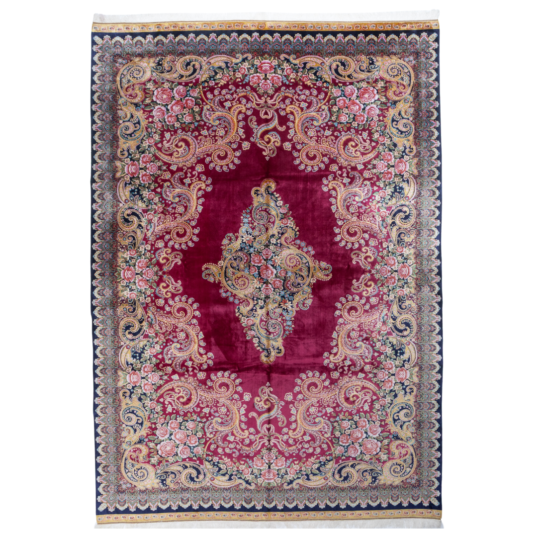 Zinia Silk Rug with crimson red base, floral medallion pattern, intricate gold scrolls, and a navy border, crafted in fine silk with detailed motifs.