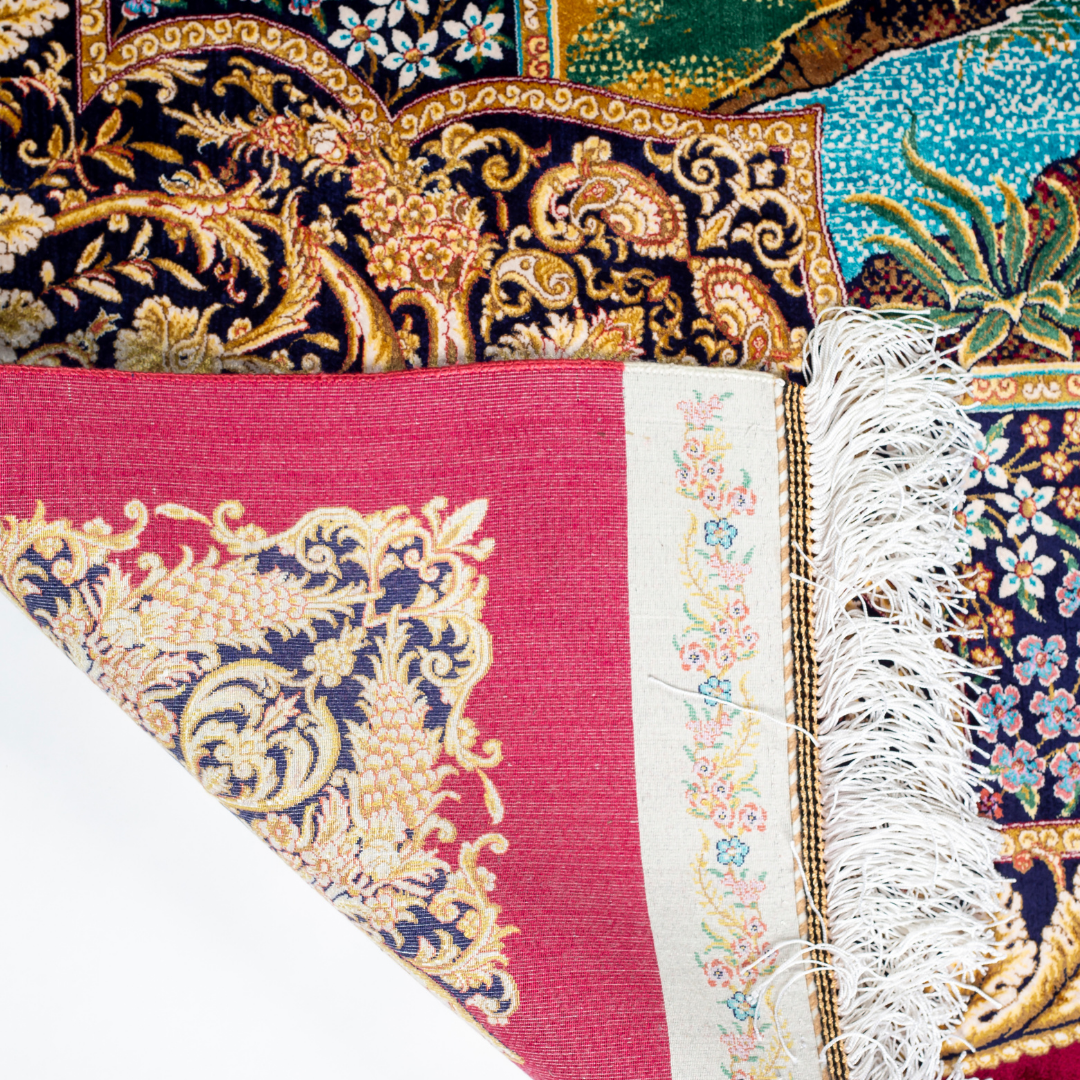 Silk rug with tree of life and bird motif, burgundy floral base, and ornate navy-gold borders. Handwoven with artistic precision.