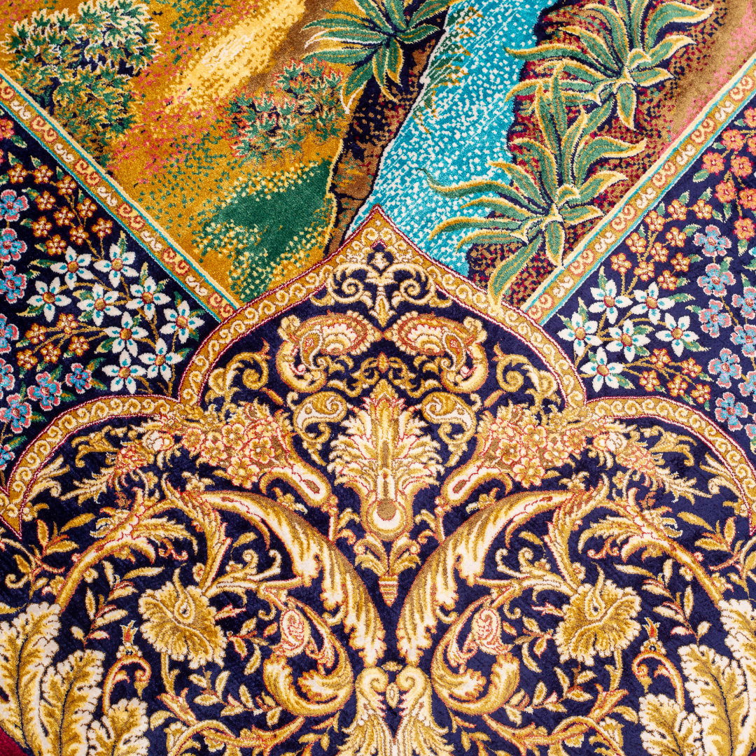 Silk rug with tree of life and bird motif, burgundy floral base, and ornate navy-gold borders. Handwoven with artistic precision.