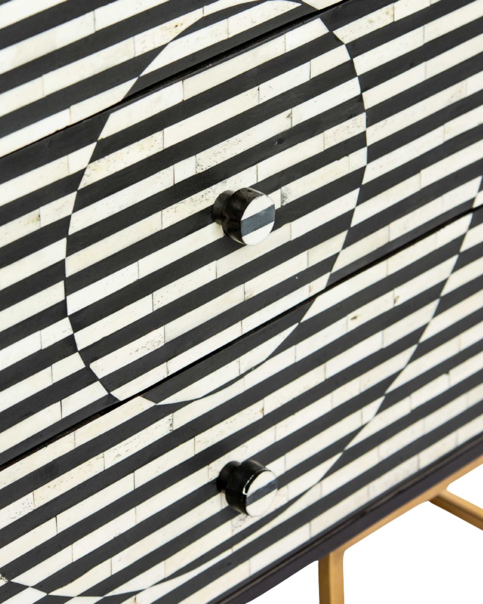 Black and white geometric bone inlay chest of drawers with gold base.