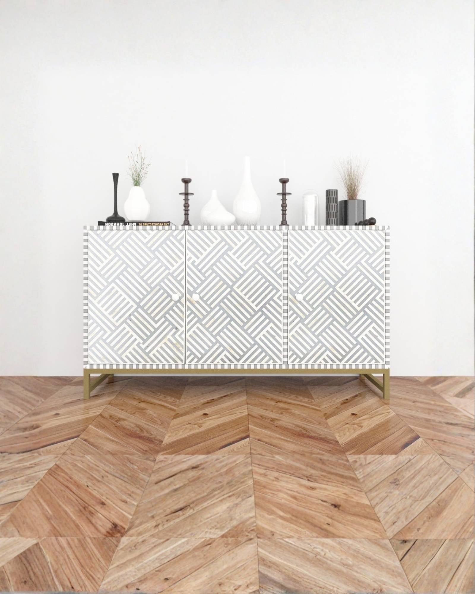 Handcrafted Grey Cabinet with intricate Bone inlay, featuring a striped pattern and sleek Metal legs. A luxurious storage solution for any space.