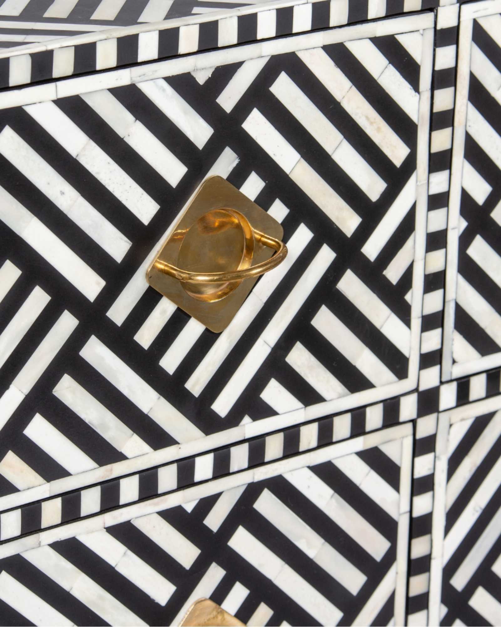 Luxury black and white bone inlay chest of drawers with brass accents and geometric design, handcrafted for statement interiors.