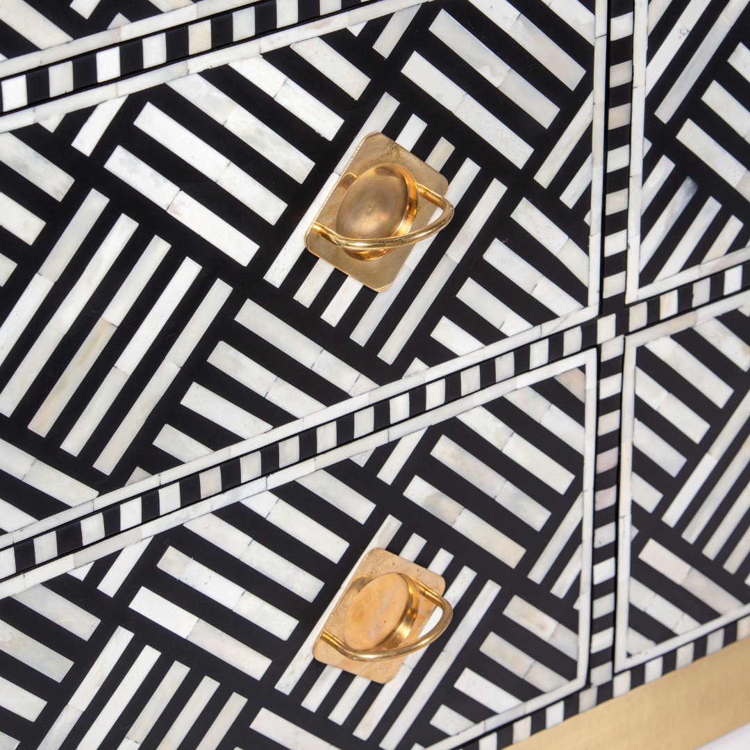 Luxury black and white bone inlay chest of drawers with brass accents and geometric design, handcrafted for statement interiors.