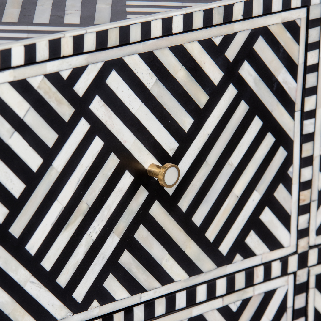 Luxury black and white bone inlay chest of drawers with brass accents and geometric design, handcrafted for statement interiors.