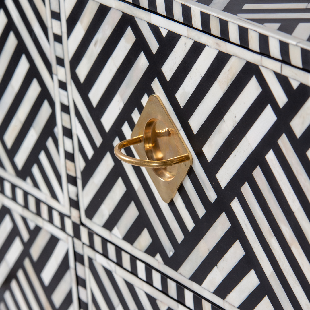 Luxury black and white bone inlay chest of drawers with brass accents and geometric design, handcrafted for statement interiors.