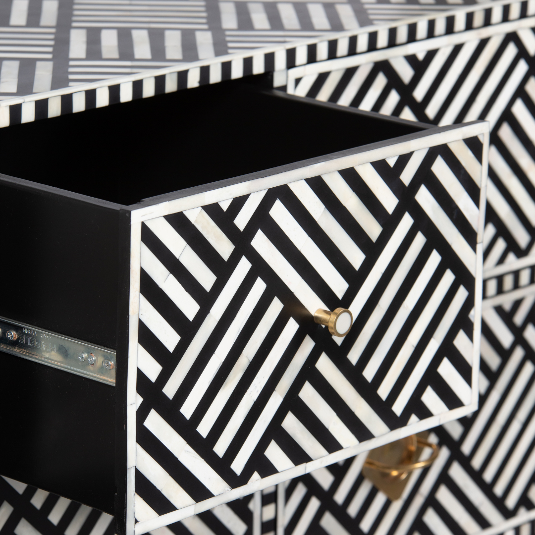 Luxury black and white bone inlay chest of drawers with brass accents and geometric design, handcrafted for statement interiors.