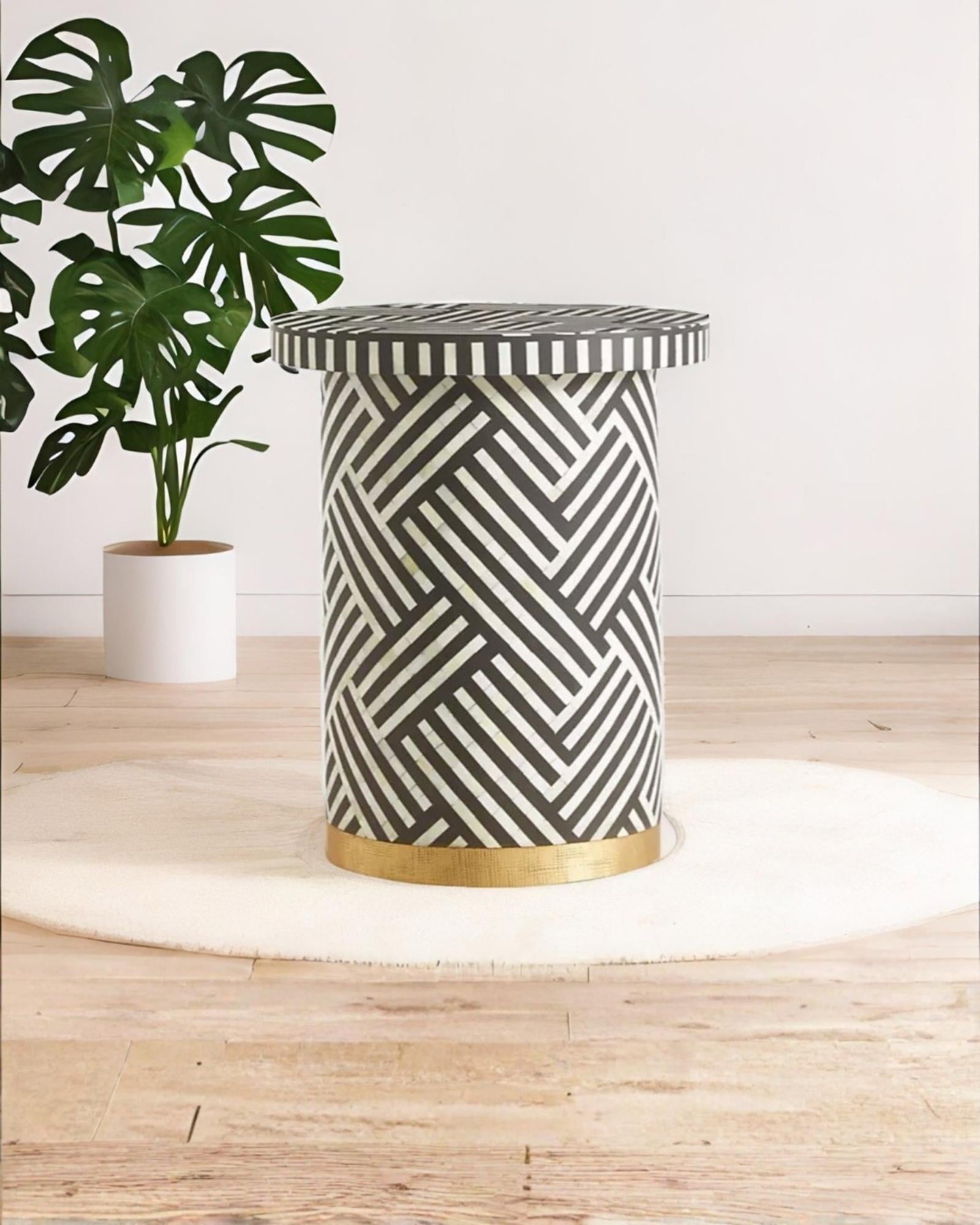 Black bone inlay side table with bold striped pattern, handcrafted with a brass base accent, ideal for modern interiors.