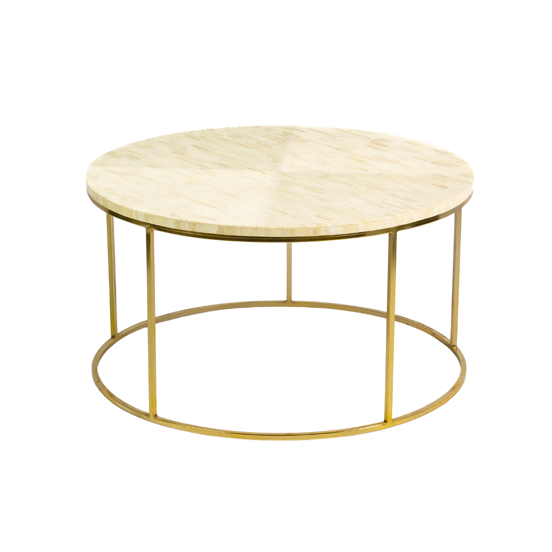 Ivory bone carved coffee table with linear textured pattern and gold metal circular frame by Tabeer Homes.