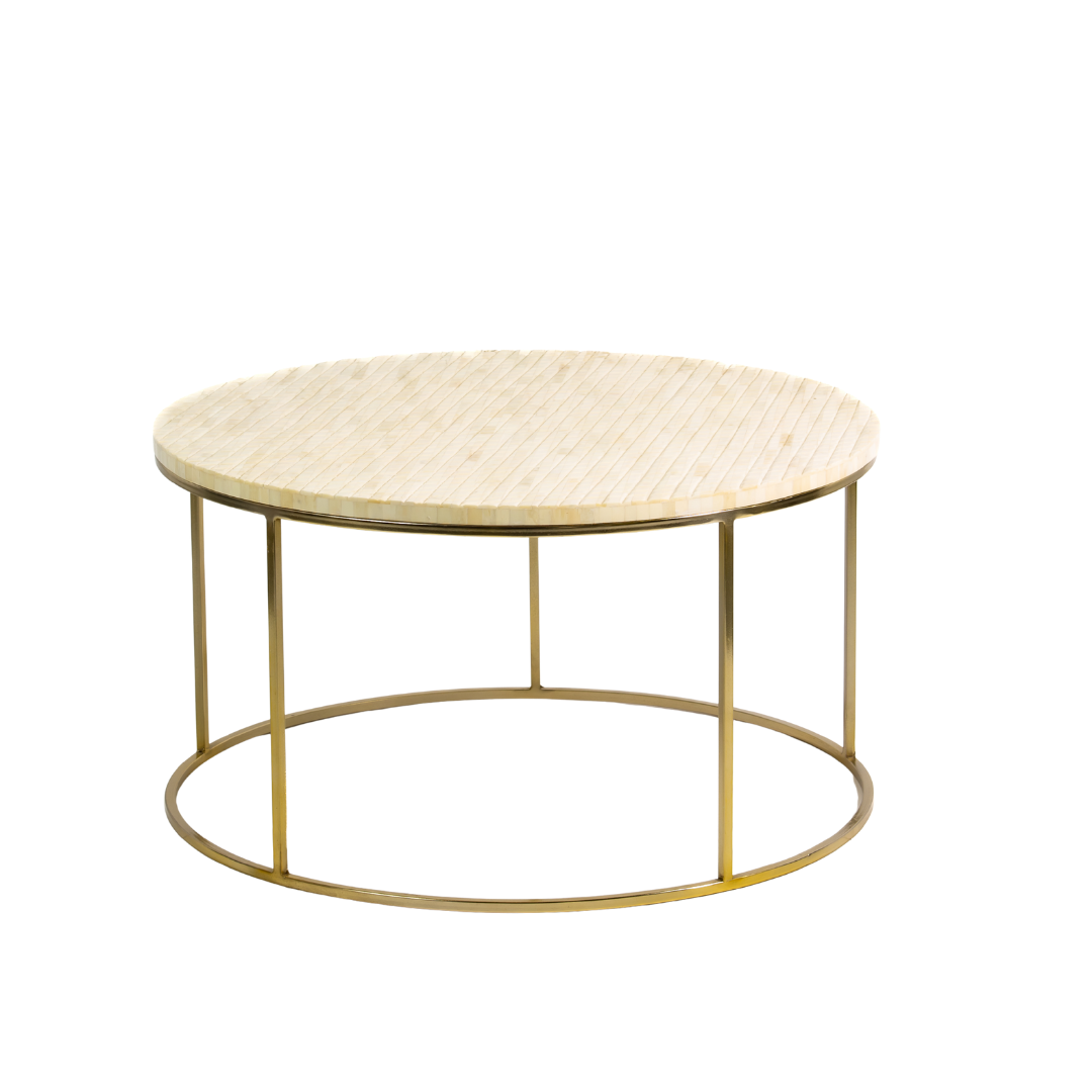 Ivory bone carved coffee table with linear textured design and brushed gold circular metal base by Tabeer Homes.
