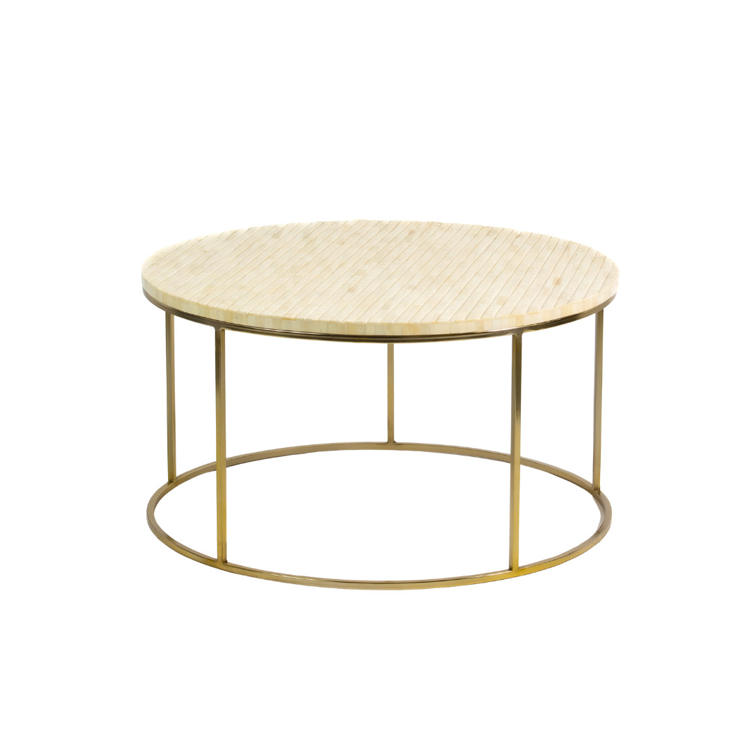 Ivory bone carved coffee table with linear textured design and brushed gold circular metal base by Tabeer Homes.