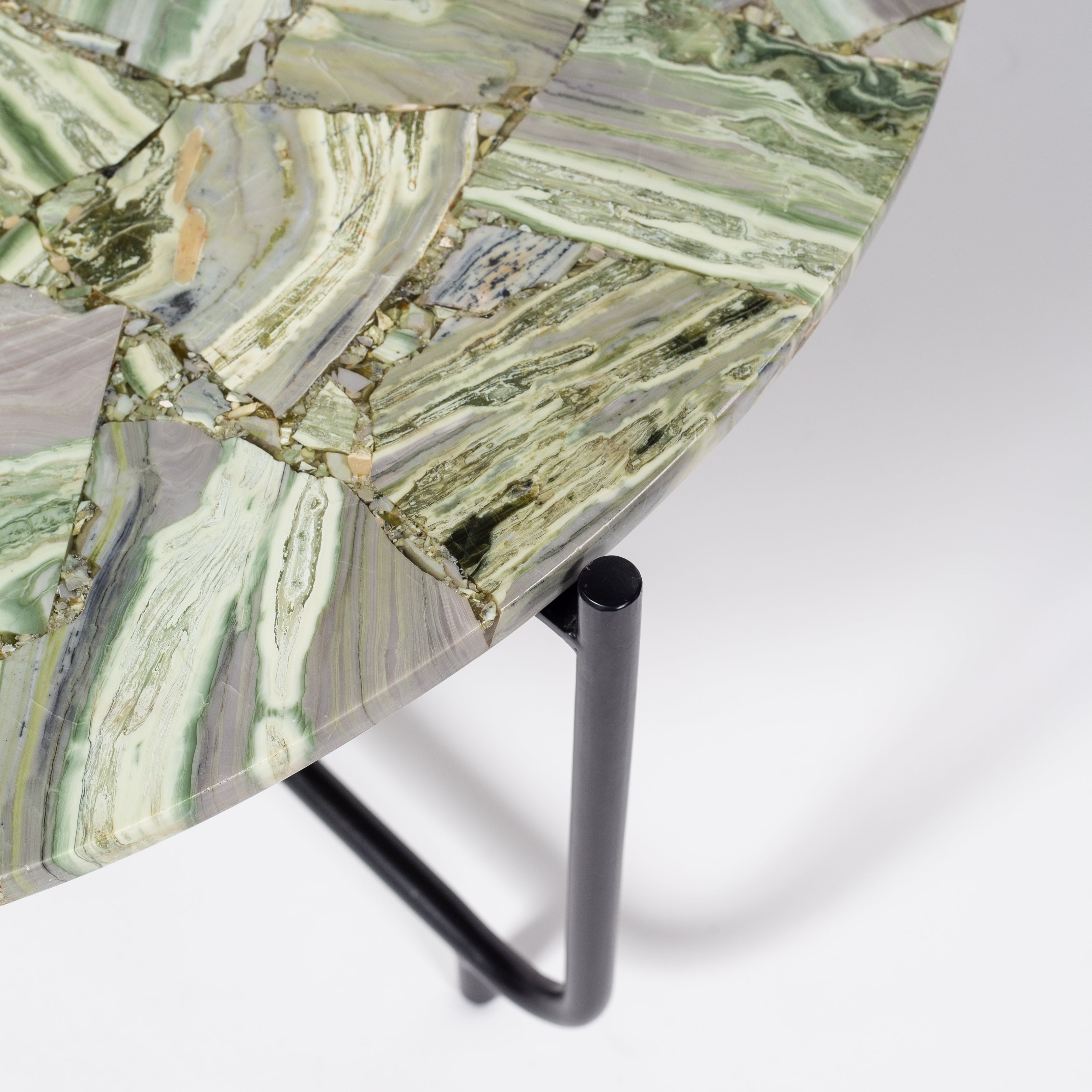 Handcrafted agate coffee table with round stone top and black metal base, artisan-made heritage piece.