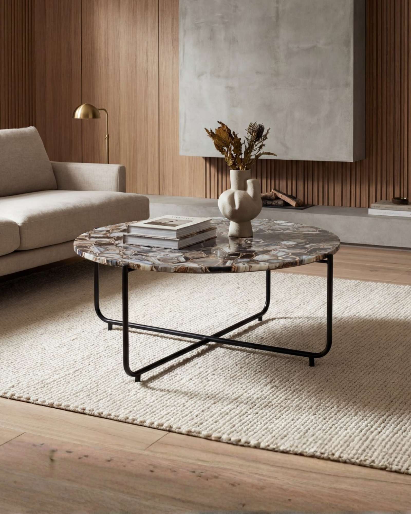 Round coffee table with genuine agate stone top and sleek black metal base, modern and luxurious centerpiece design.