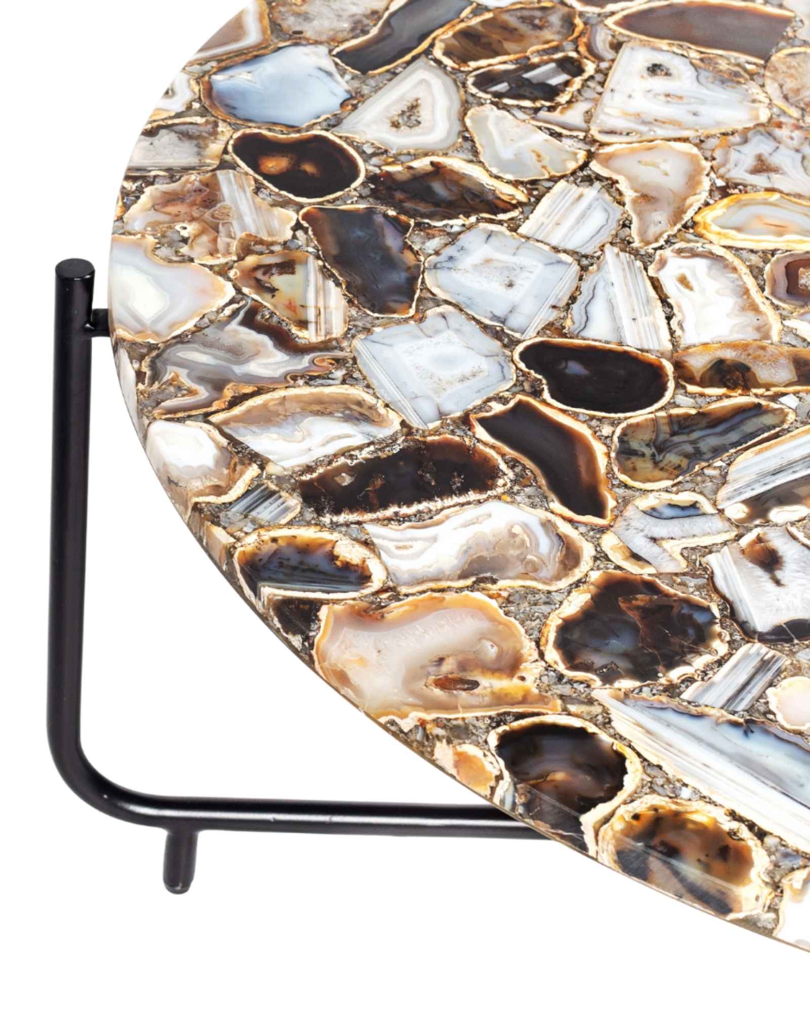 Round coffee table with genuine agate stone top and sleek black metal base, modern and luxurious centerpiece design.