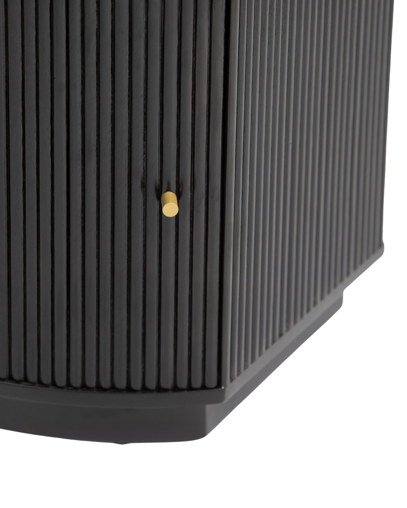 Wooden side drawer featuring fluted texture in black with brass accents, handcrafted furniture piece.
