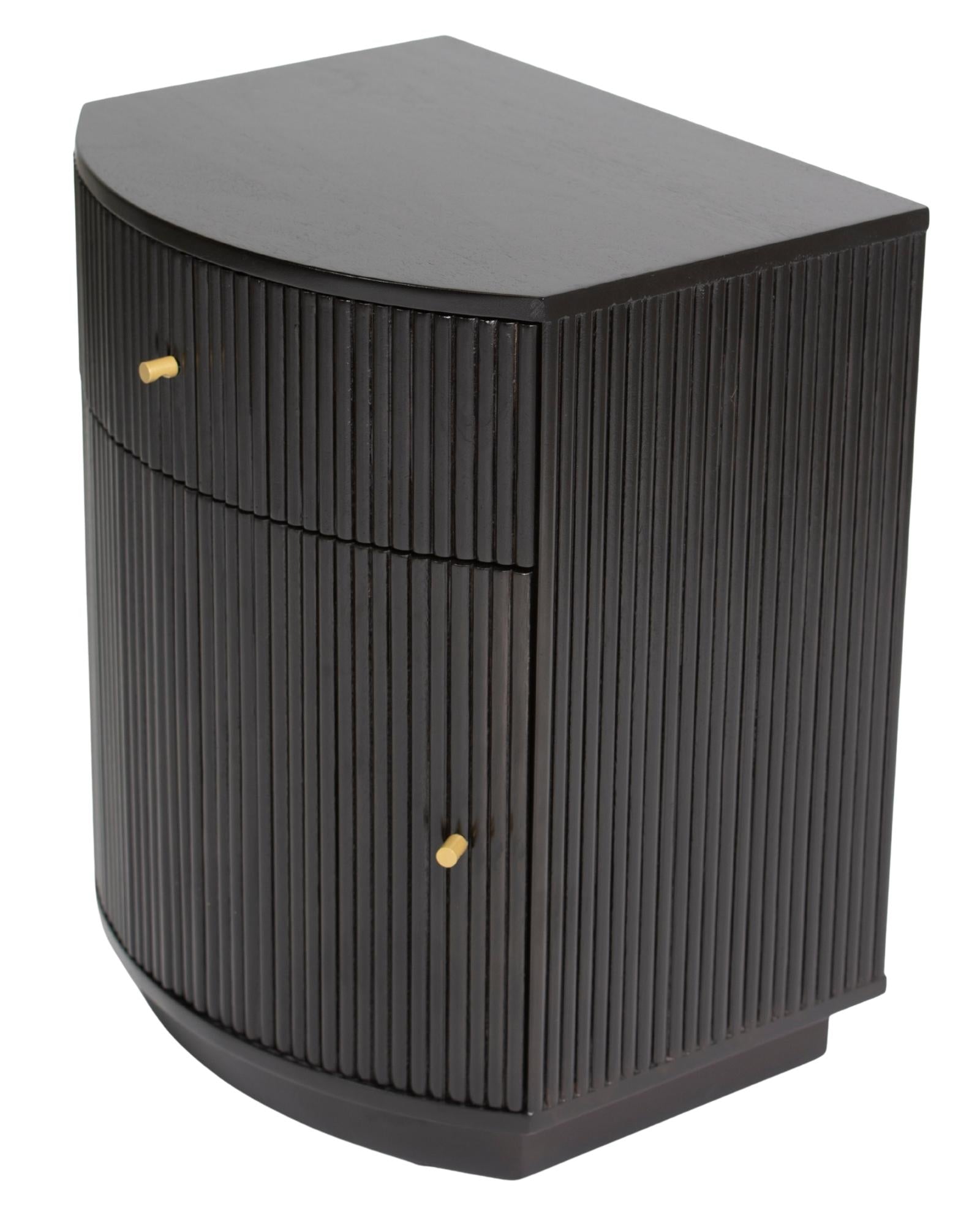 Wooden side drawer featuring fluted texture in black with brass accents, handcrafted furniture piece.