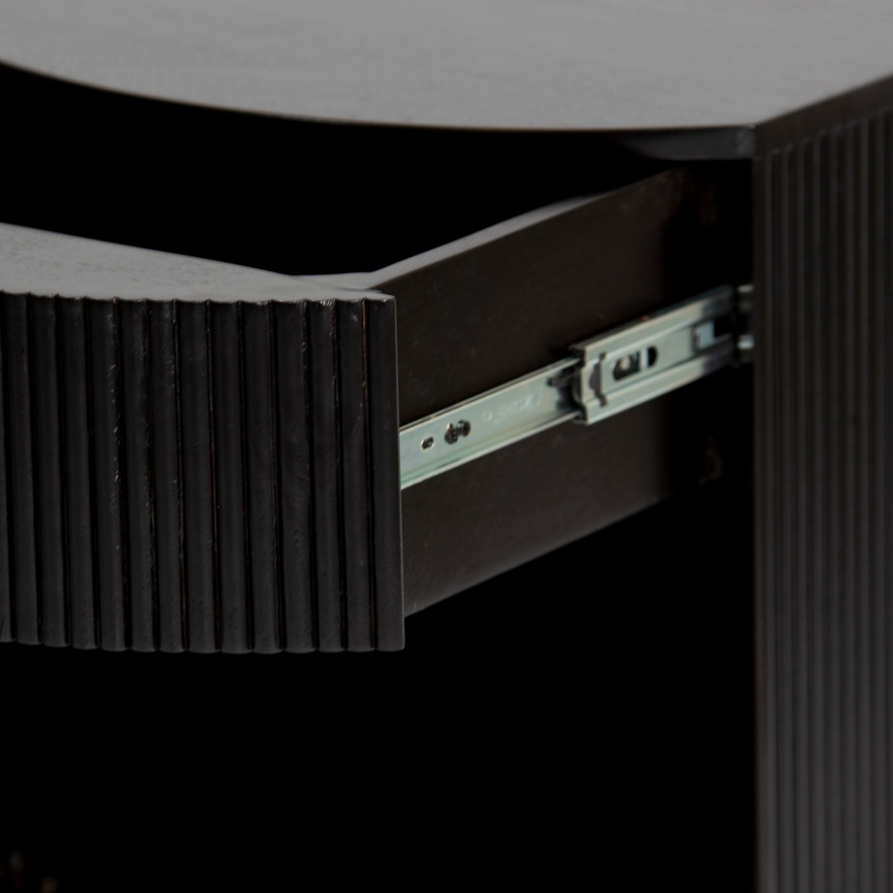 Wooden side drawer featuring fluted texture in black with brass accents, handcrafted furniture piece