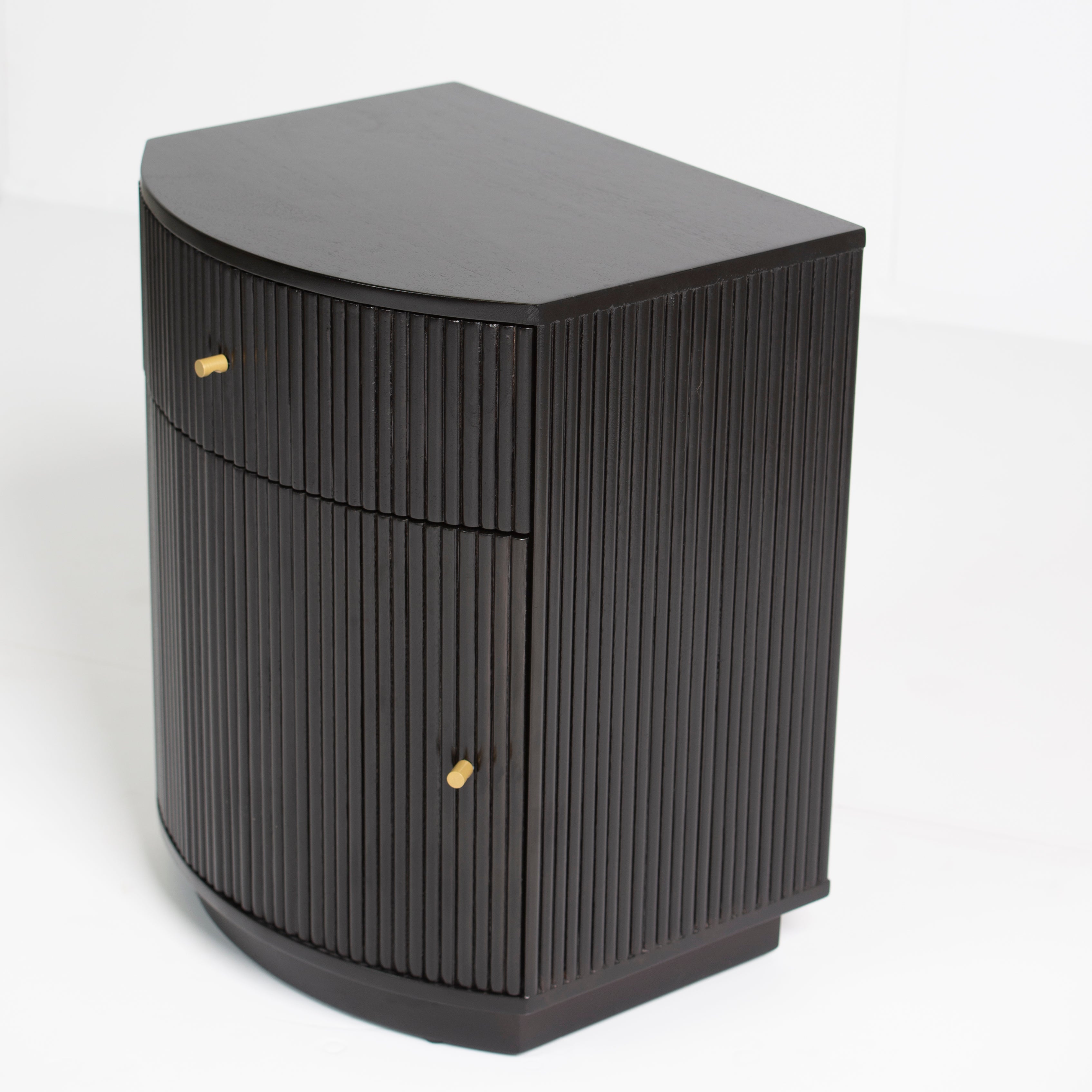 Wooden side drawer featuring fluted texture in black with brass accents, handcrafted furniture piece