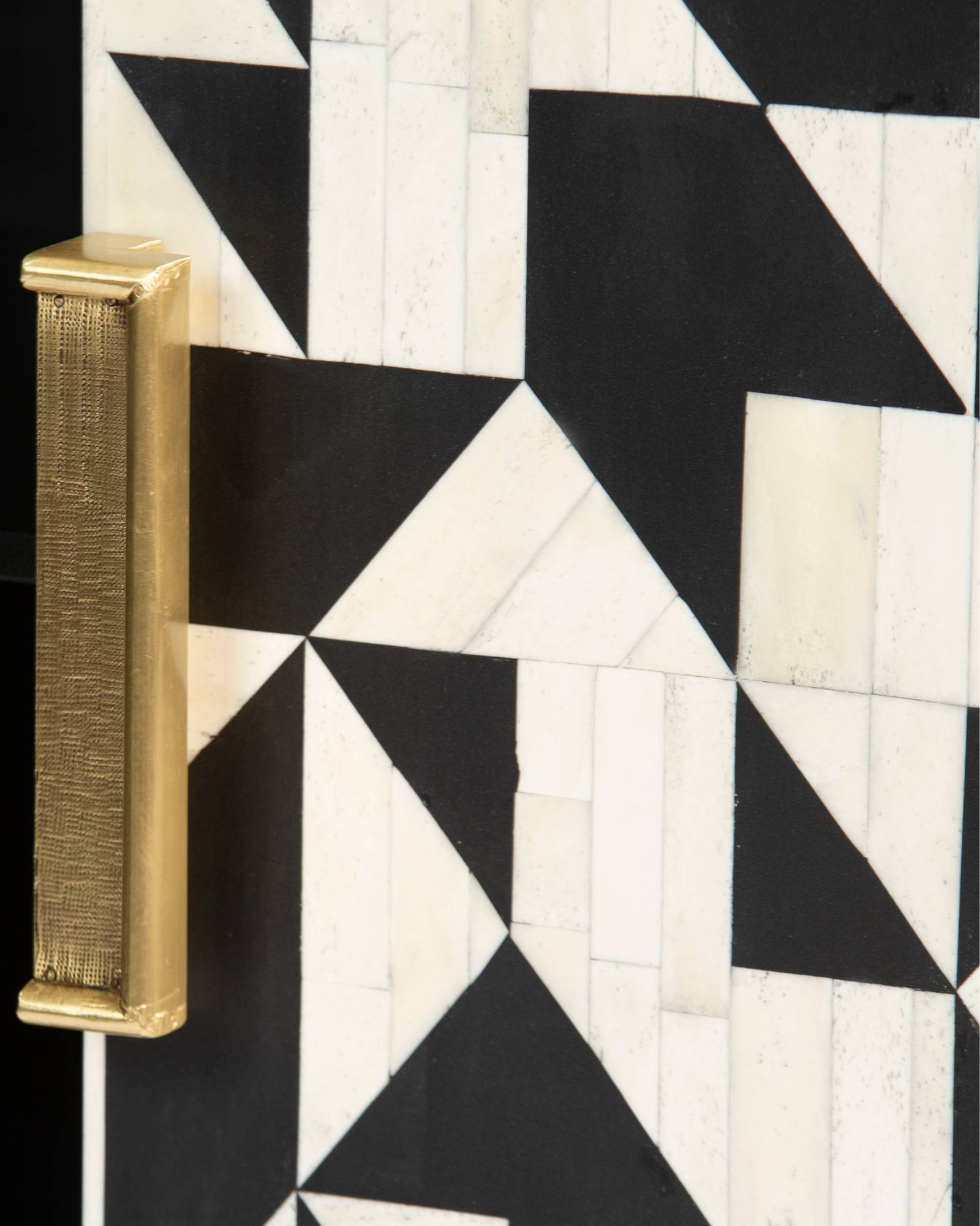 Bone inlay cabinet featuring geometric pattern in black and white with metal base, handcrafted furniture piece.