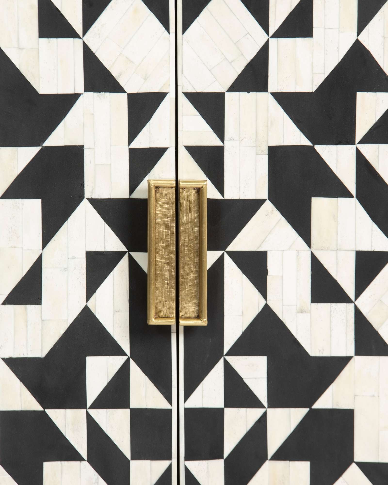 Bone inlay cabinet featuring geometric pattern in black and white with metal base, handcrafted furniture piece.