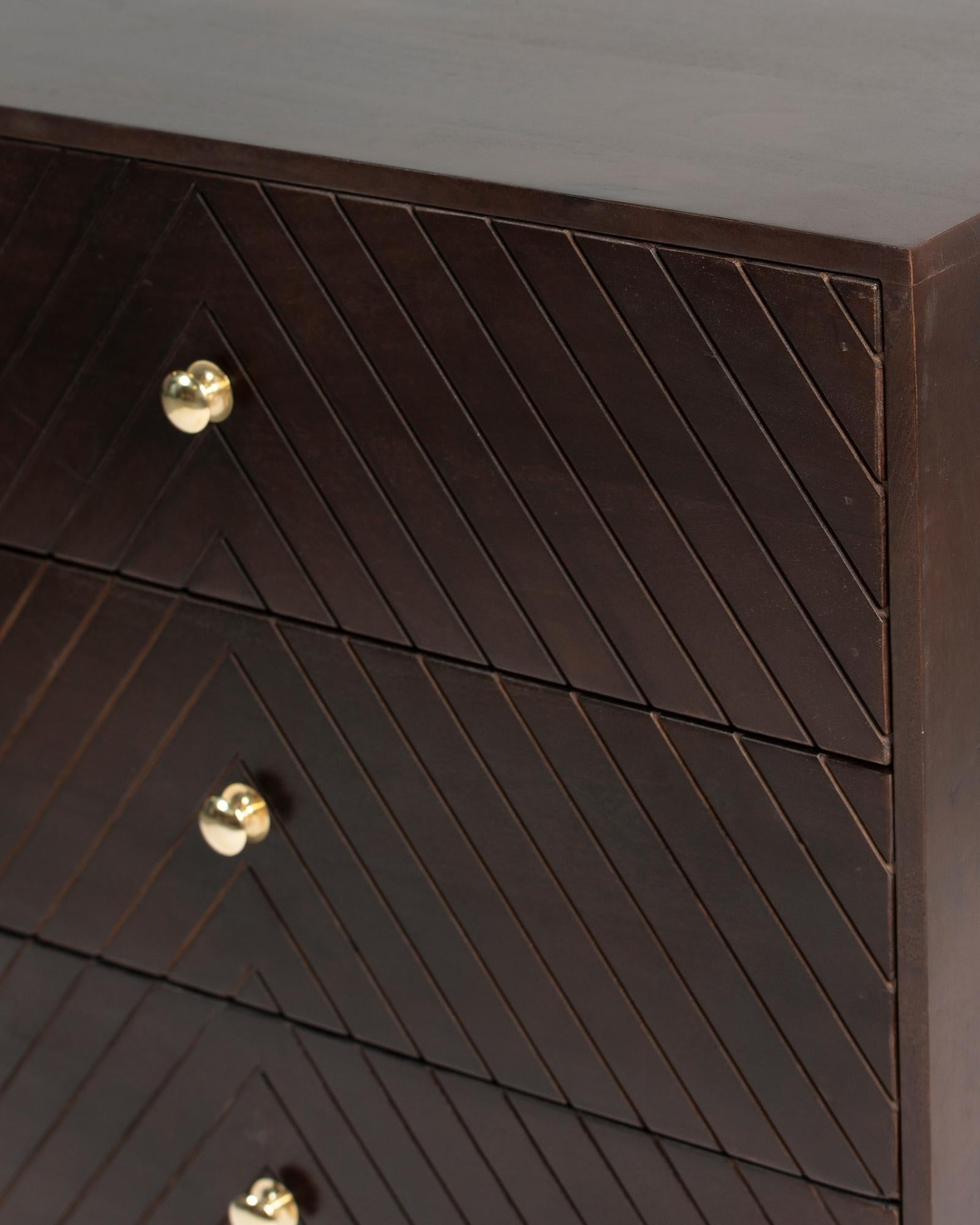 Wooden chest of drawers featuring chevron pattern in brown with brass accents, handcrafted furniture piece.