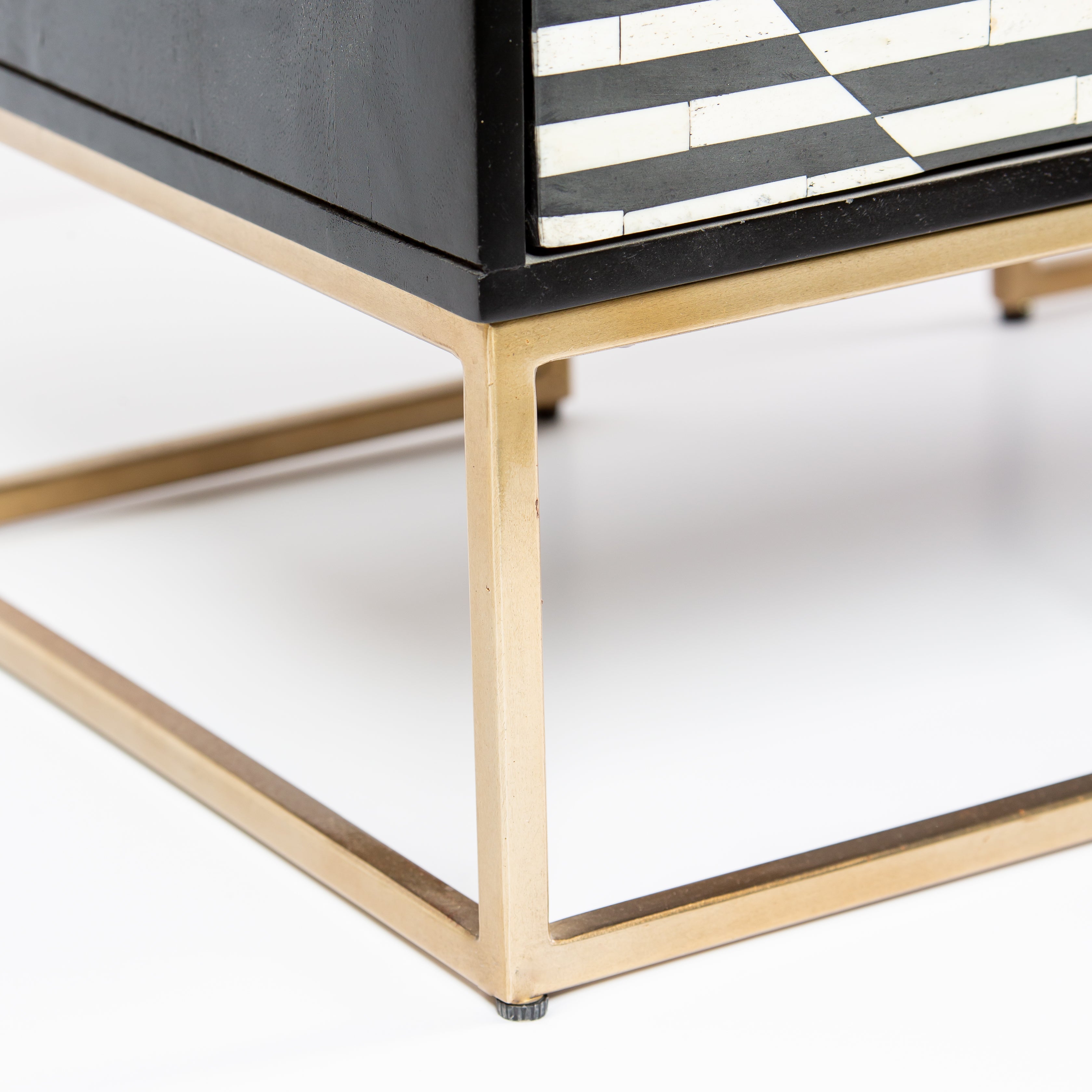 Black and white geometric bone inlay chest of drawers with gold base
