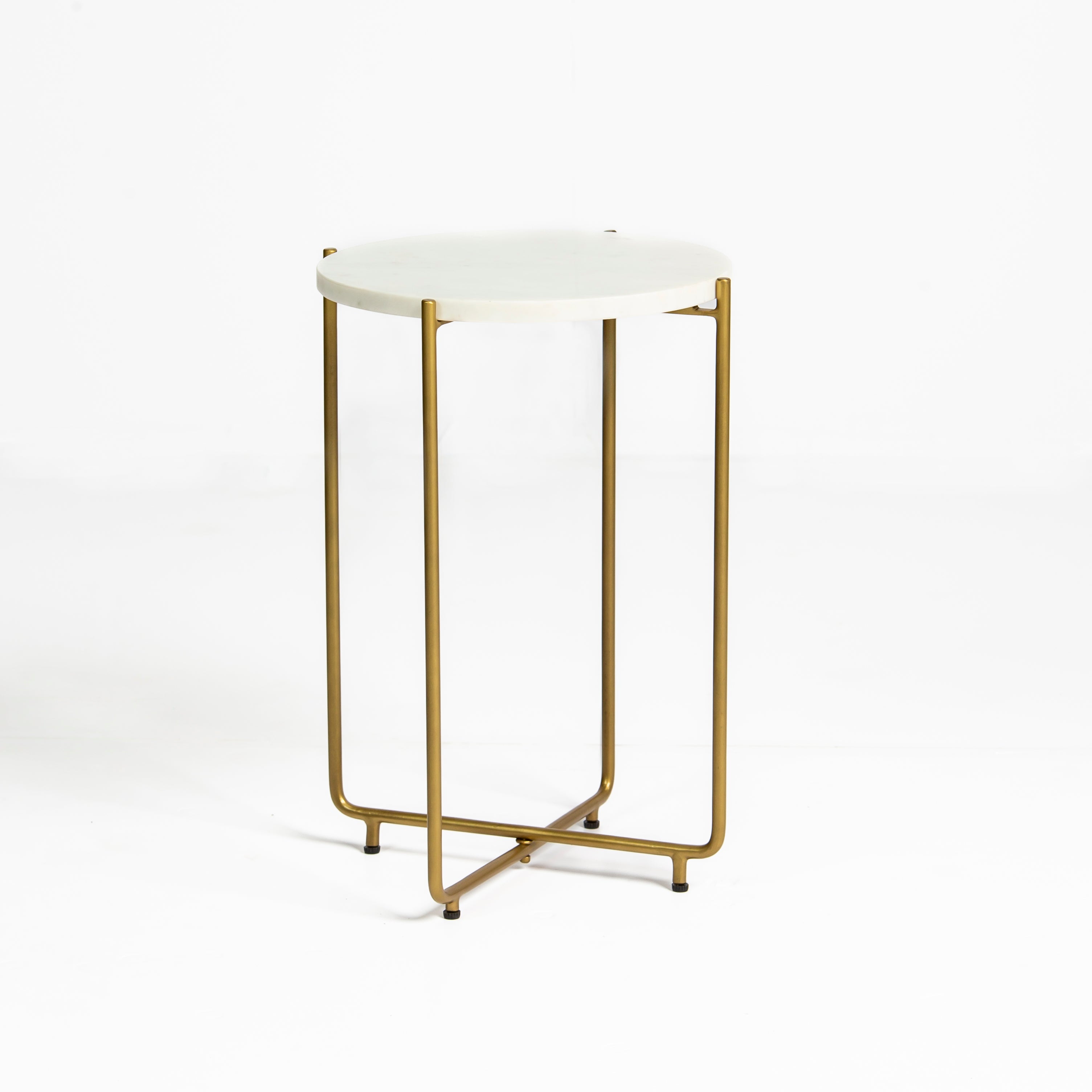 Marble side table featuring round white top with brass metal base, handcrafted furniture piece