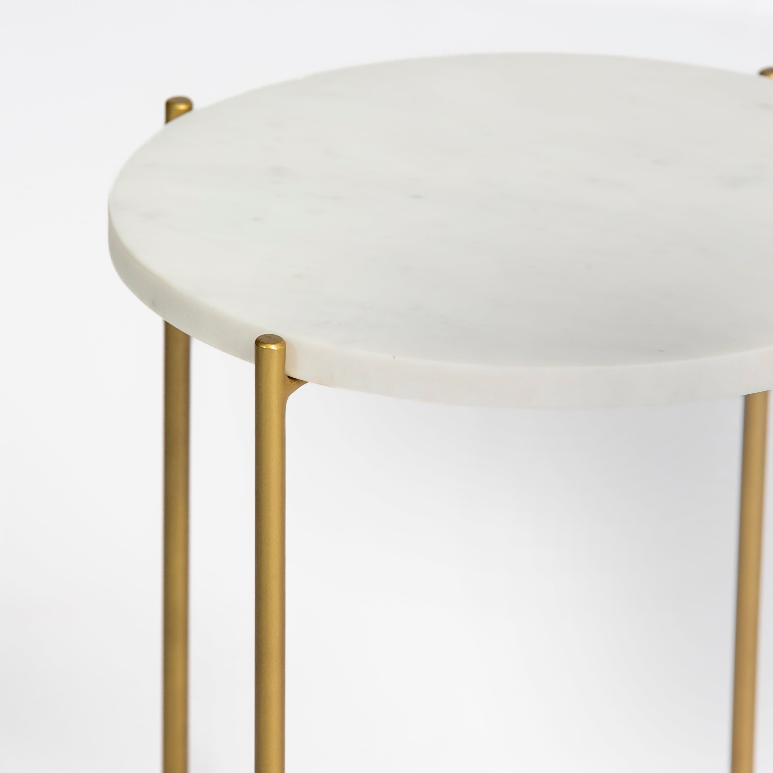 Marble side table featuring round white top with brass metal base, handcrafted furniture piece