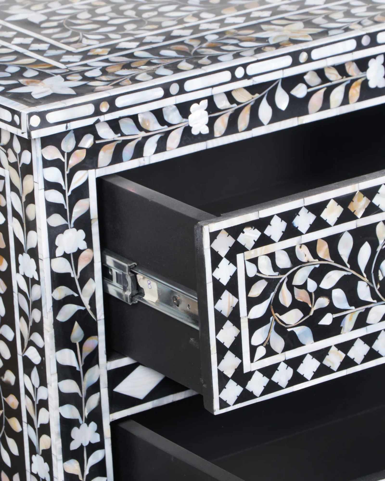 Elegant Iris Chest of Drawers in black Mother of Pearl inlay, featuring intricate floral patterns and spacious storage.
