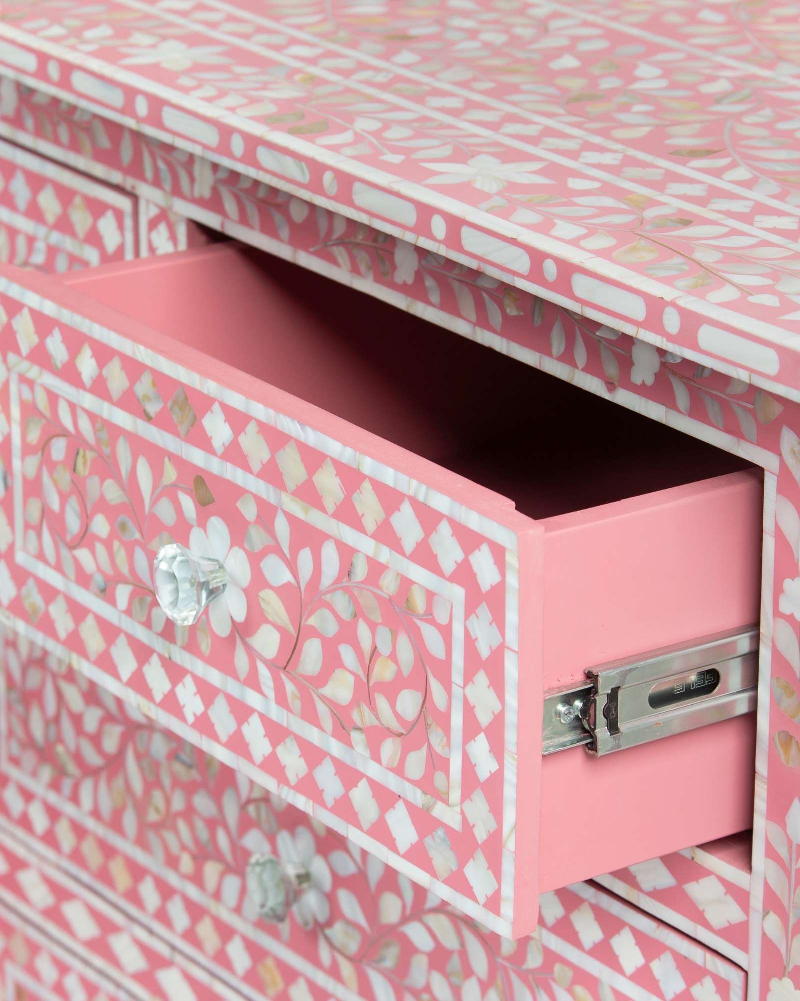Mother of pearl inlay chest of drawers featuring intricate floral pattern in pink and white, handcrafted furniture piece
