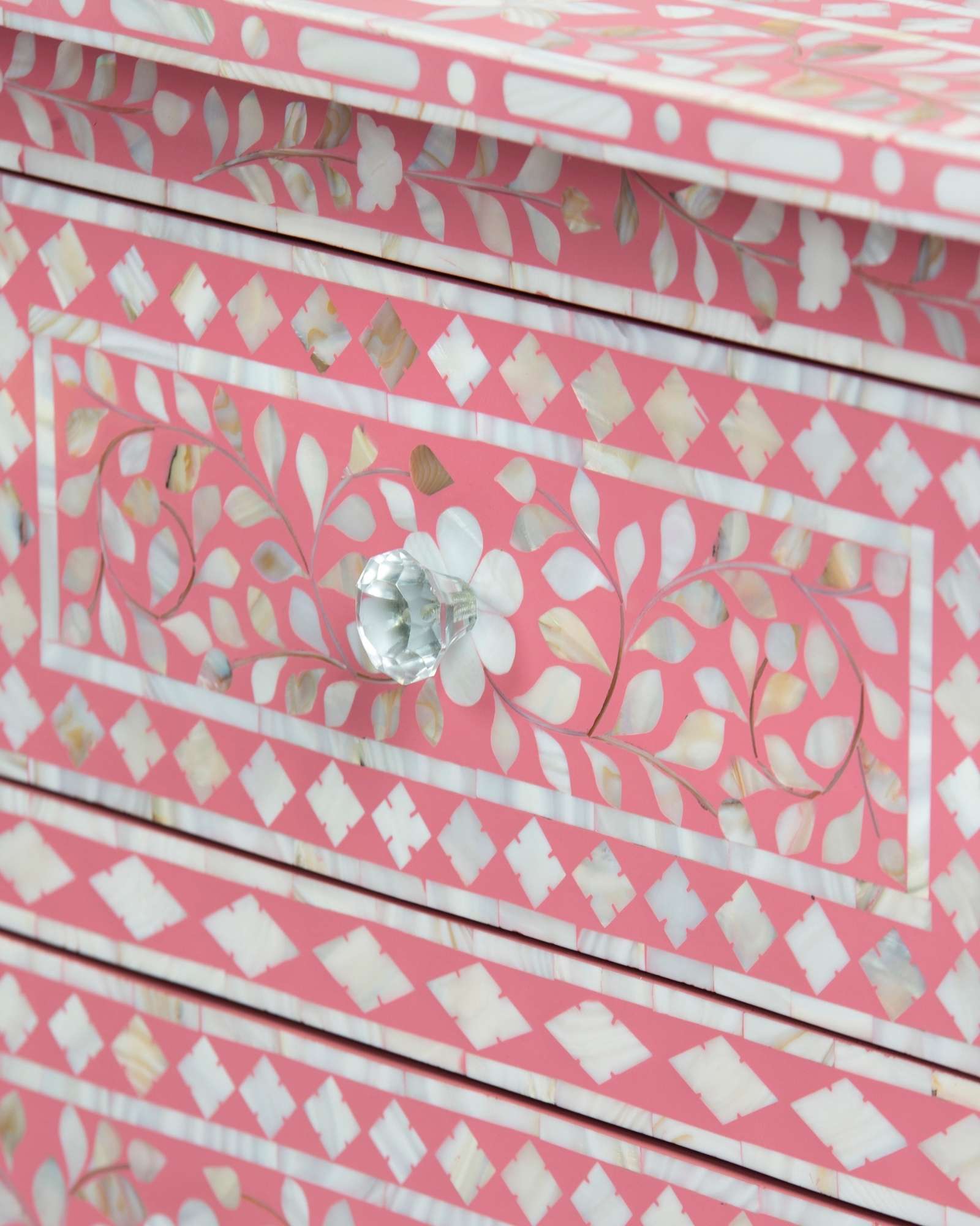 Mother of pearl inlay chest of drawers featuring intricate floral pattern in pink and white, handcrafted furniture piece