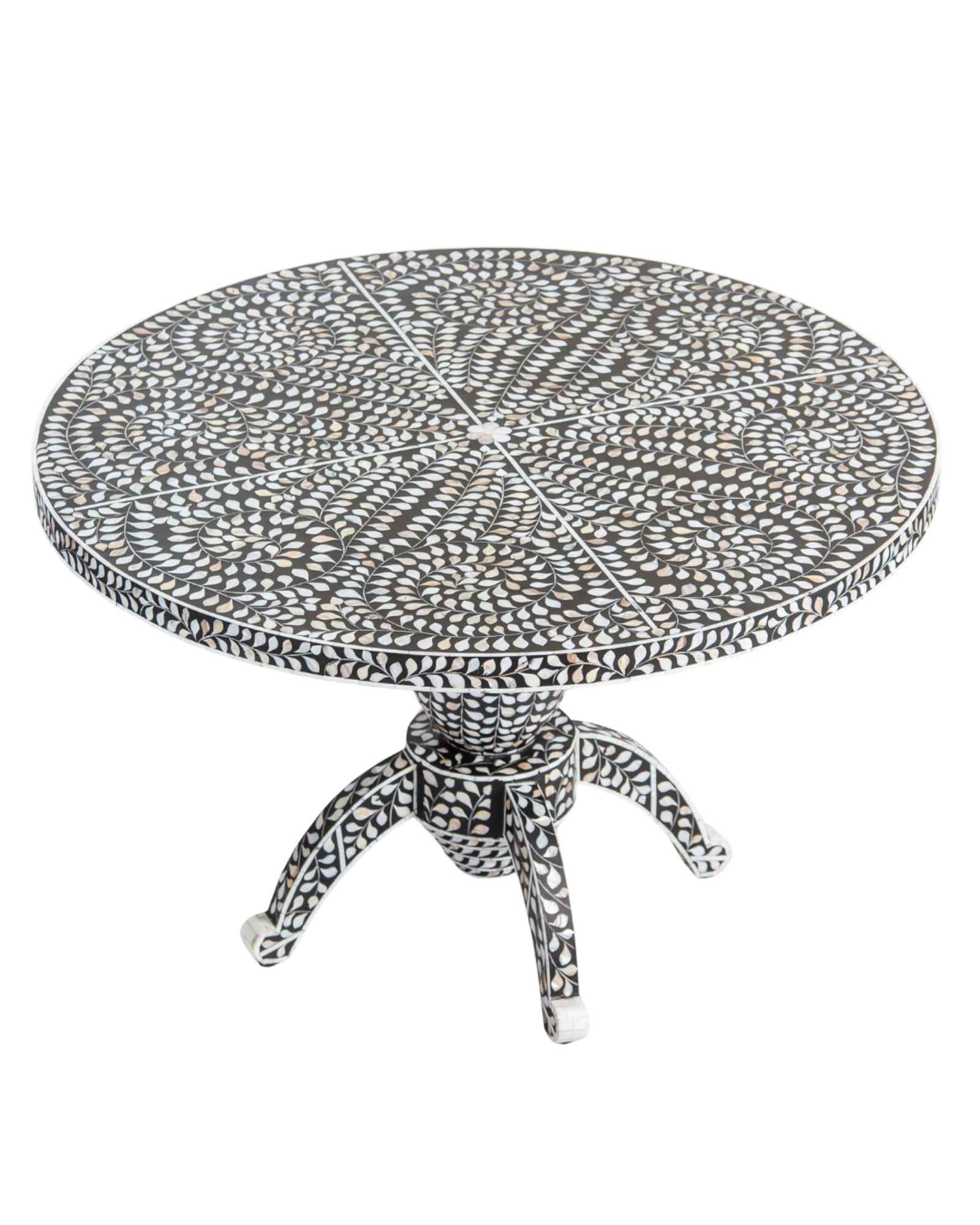 Handcrafted Iris dining table featuring black mother of pearl inlay with a round top and sculptural pedestal base.