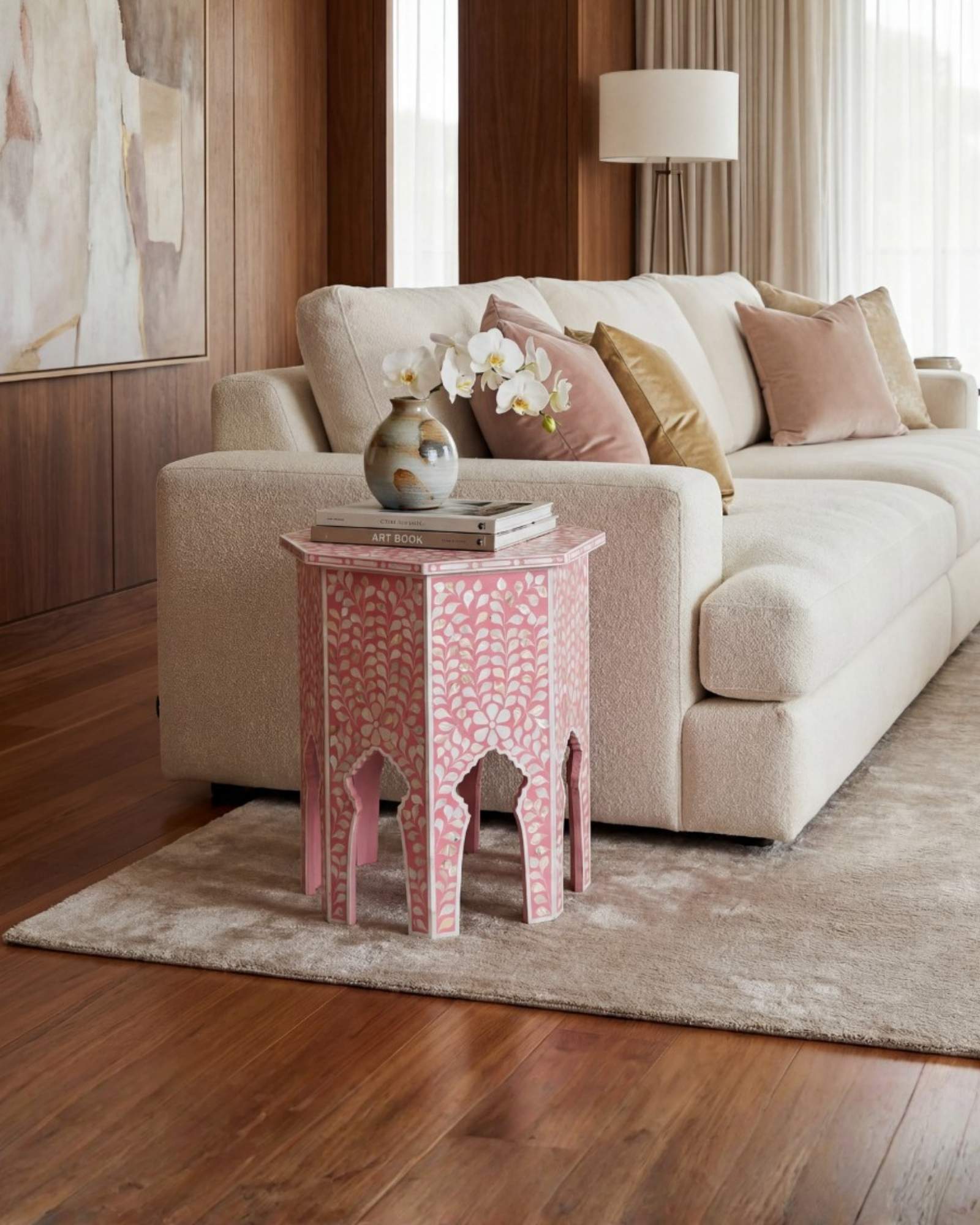 Handcrafted Iris side table featuring pink mother of pearl inlay with a hexagonal silhouette, floral detailing, and arched legs.