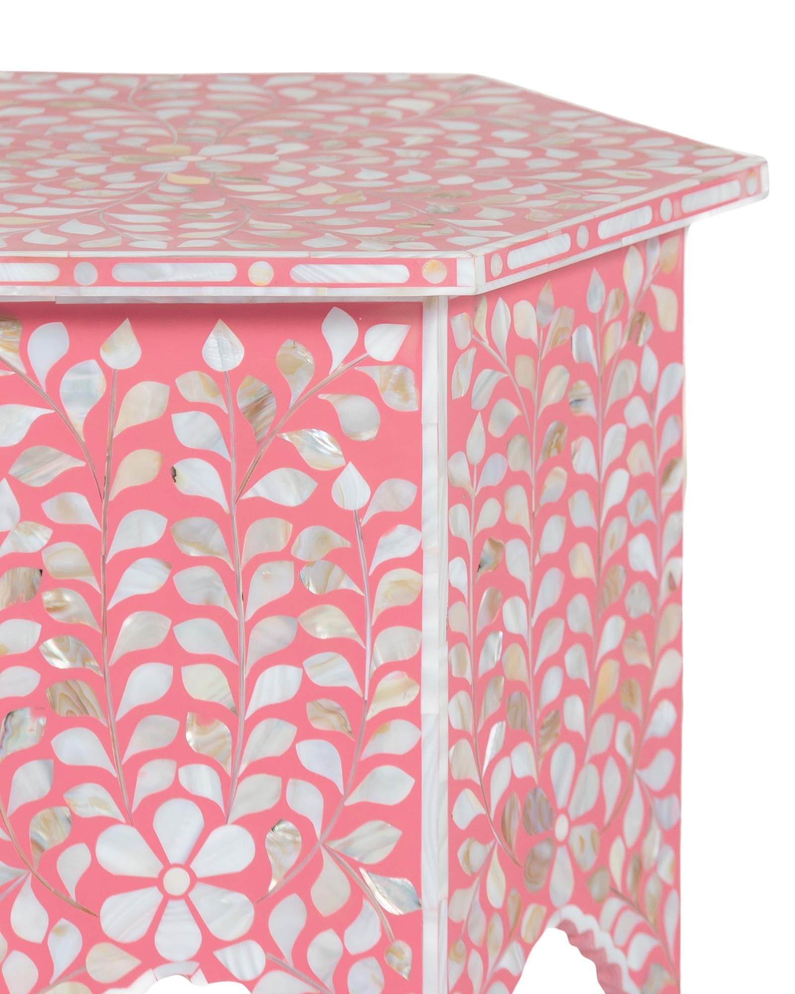 Handcrafted Iris side table featuring pink mother of pearl inlay with a hexagonal silhouette, floral detailing, and arched legs.