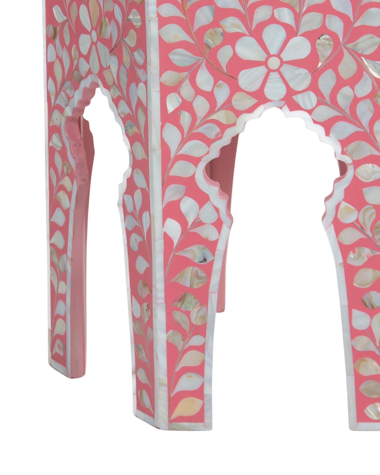 Handcrafted Iris side table featuring pink mother of pearl inlay with a hexagonal silhouette, floral detailing, and arched legs.