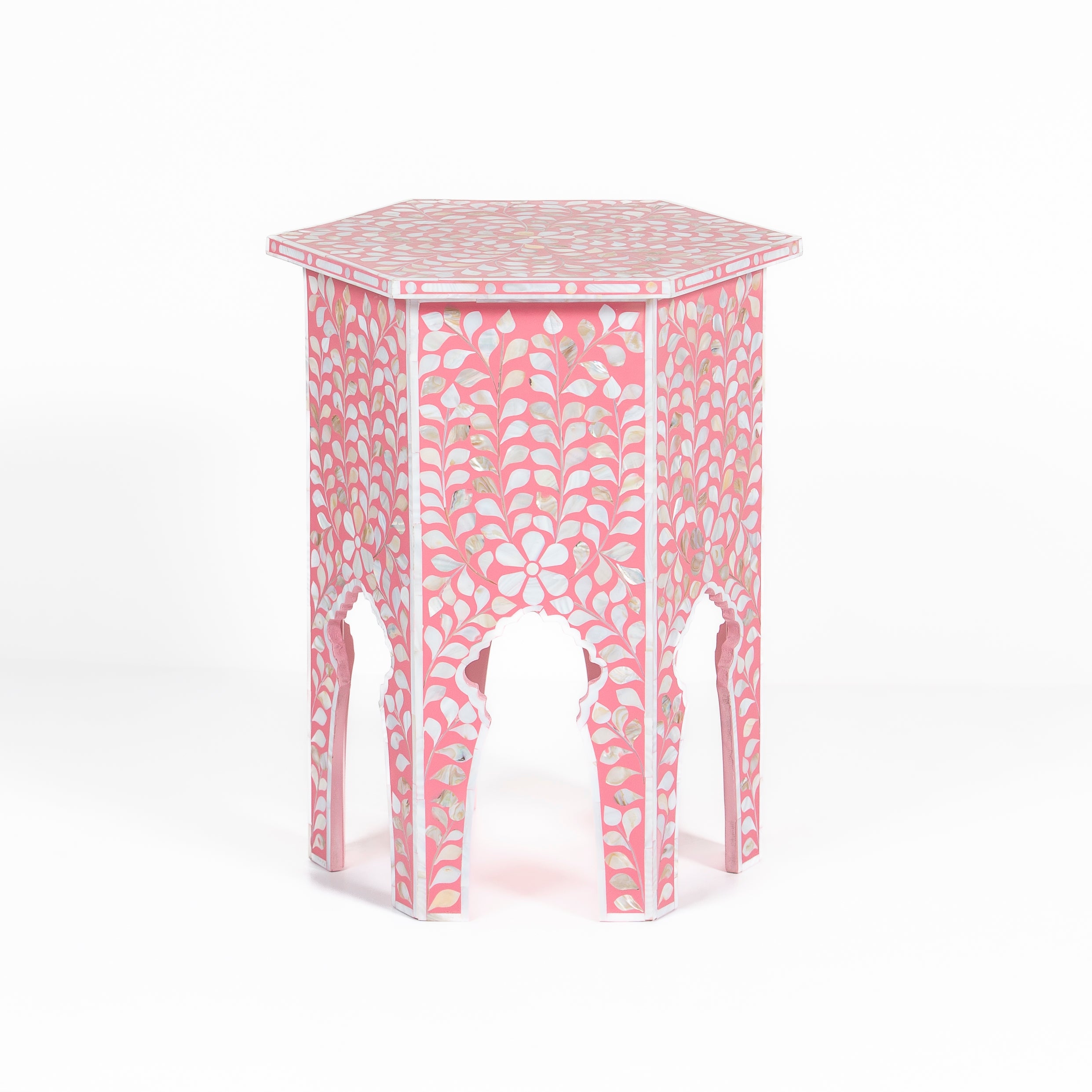 Handcrafted Iris side table featuring pink mother of pearl inlay with a hexagonal silhouette, floral detailing, and arched legs.