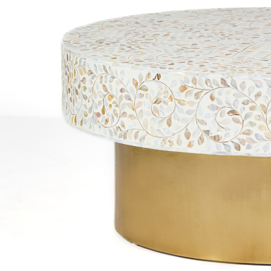 White mother of pearl inlay coffee table featuring intricate floral vine design and brushed gold cylindrical base by Tabeer Homes.