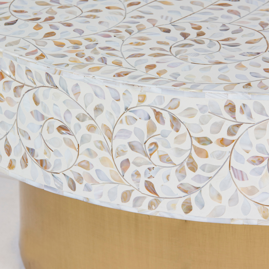 White mother of pearl inlay coffee table featuring intricate floral vine design and brushed gold cylindrical base by Tabeer Homes.
