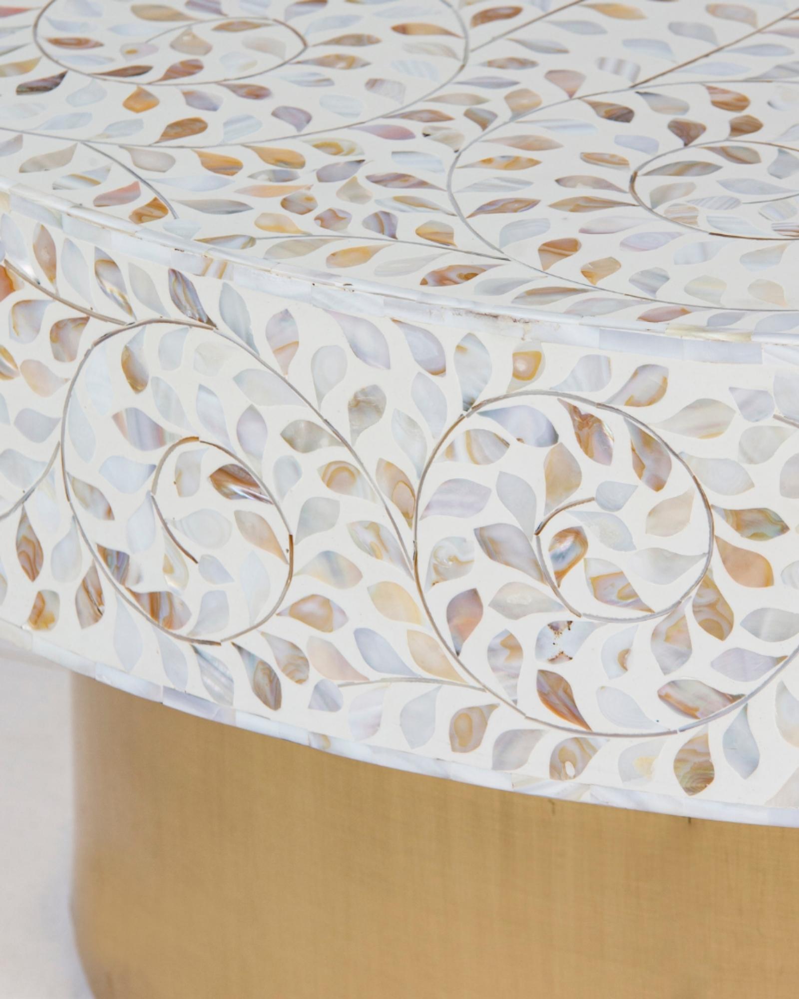 White mother of pearl inlay coffee table featuring intricate floral vine design and brushed gold cylindrical base by Tabeer Homes.
