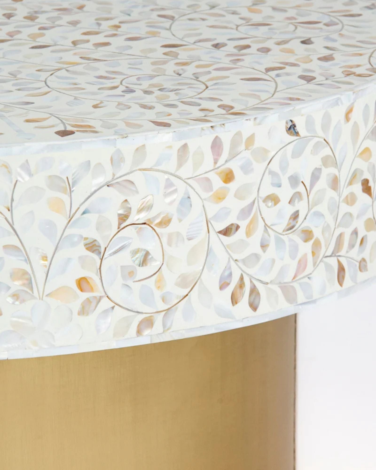 White mother of pearl inlay coffee table featuring intricate floral vine design and brushed gold cylindrical base by Tabeer Homes.