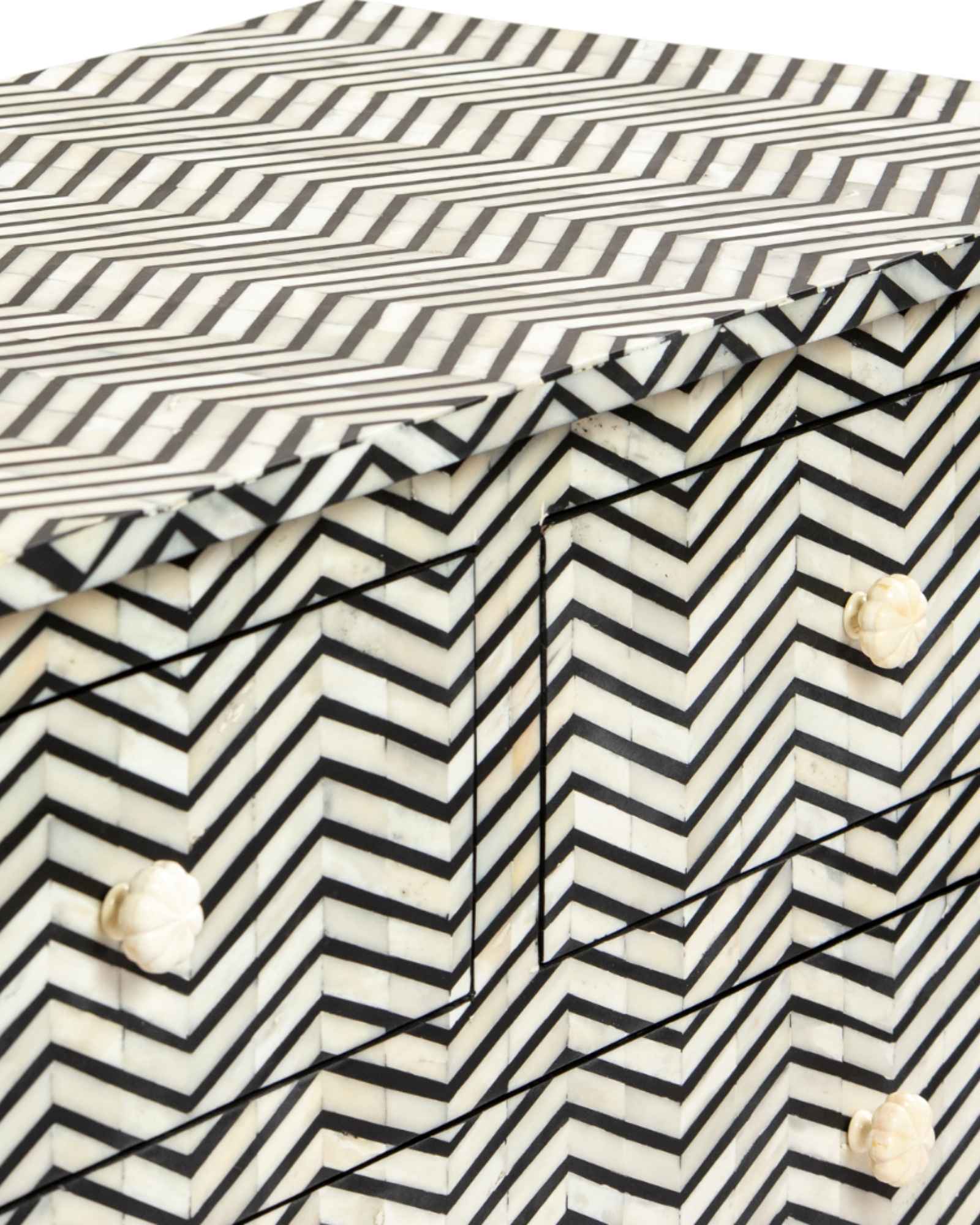 Featuring a Black Bone Inlay Chest of Drawer in chevron pattern, the Isra collection enhances your space with intricately handcrafted designs that elevate your home and living aesthetics. 