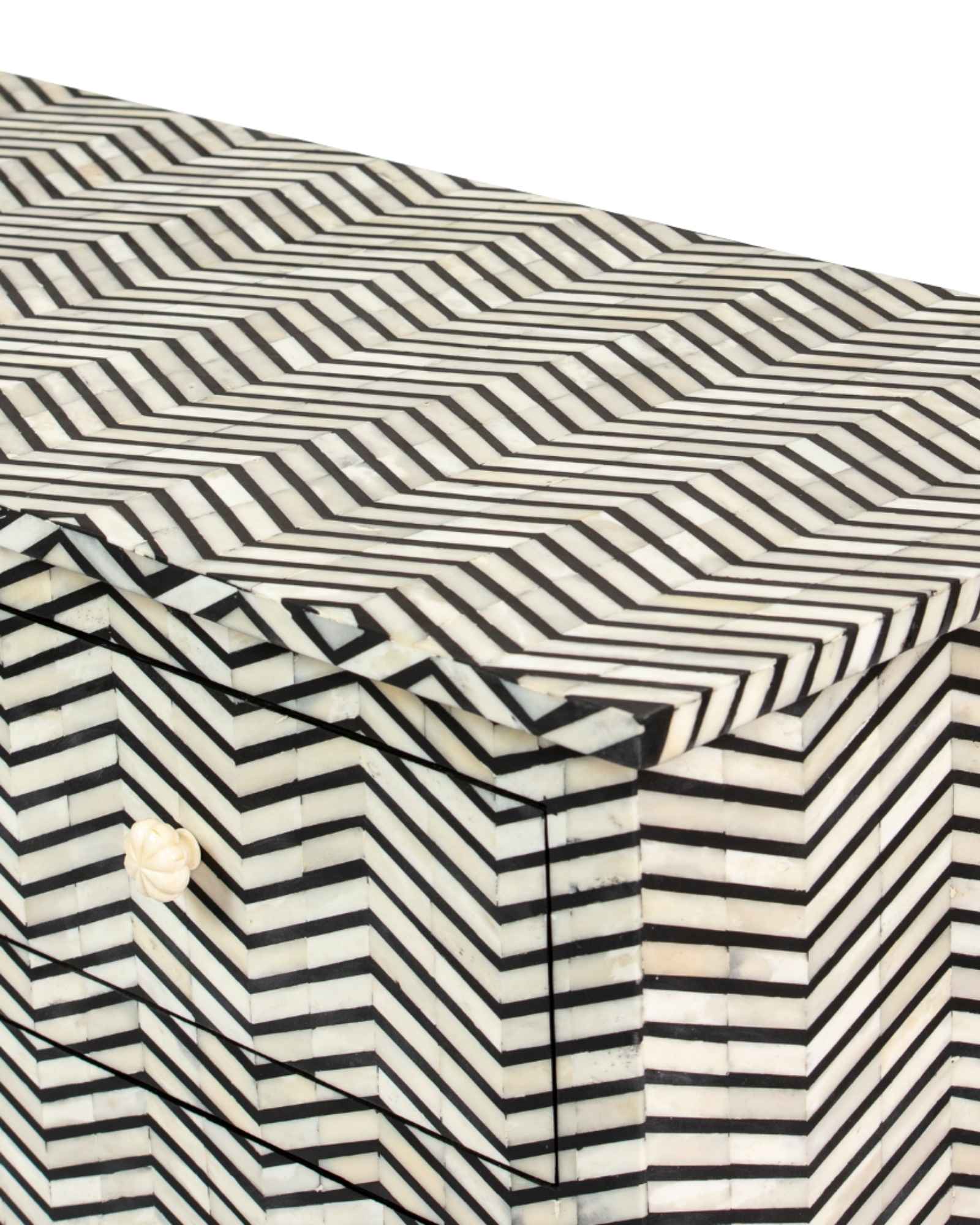 Featuring a Black Bone Inlay Chest of Drawer in chevron pattern, the Isra collection enhances your space with intricately handcrafted designs that elevate your home and living aesthetics. 