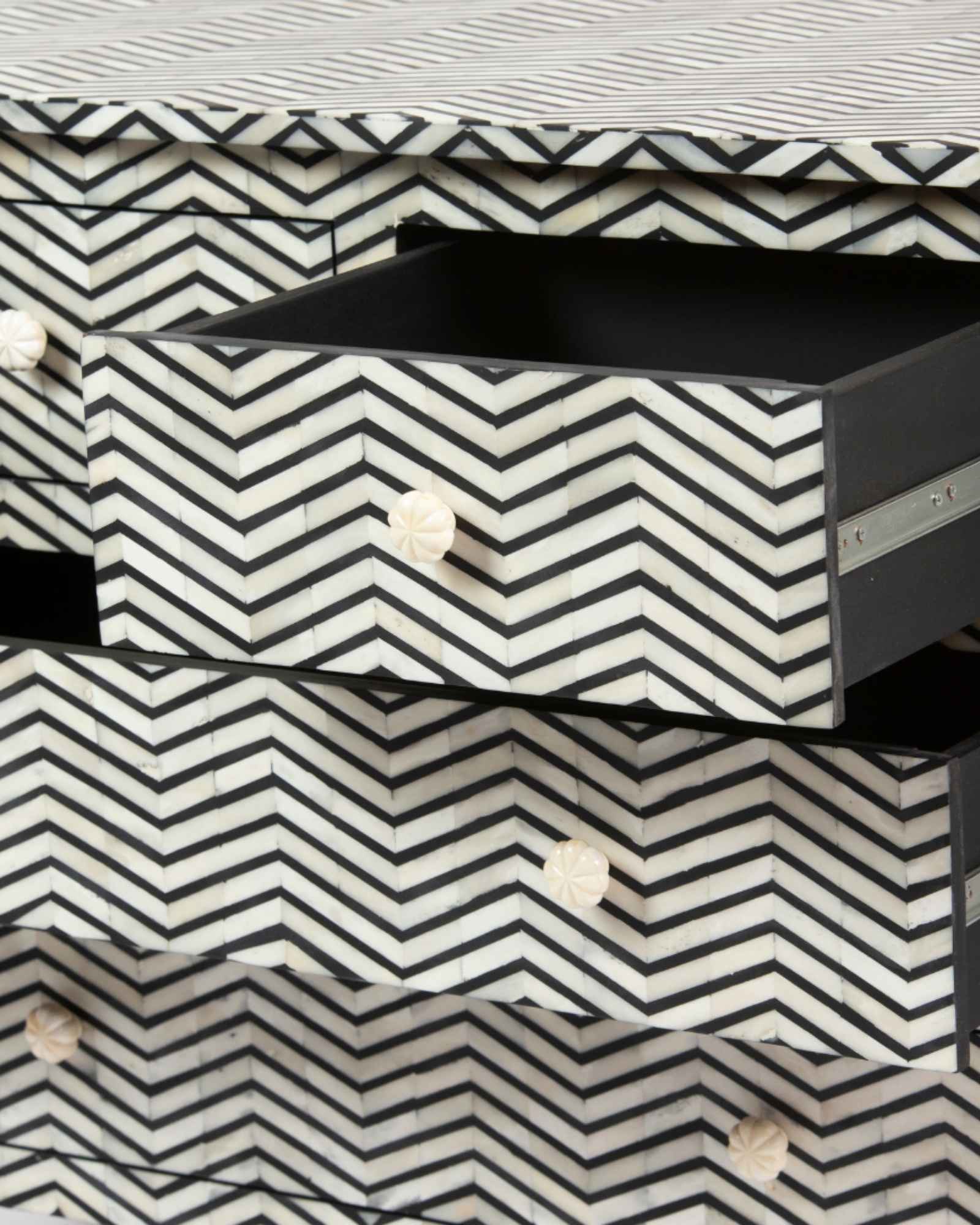Featuring a Black Bone Inlay Chest of Drawer in chevron pattern, the Isra collection enhances your space with intricately handcrafted designs that elevate your home and living aesthetics. 