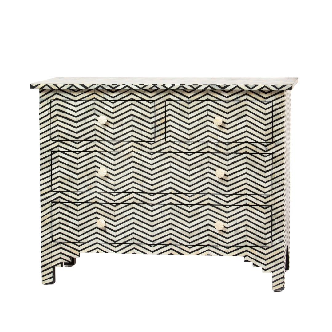 Featuring a Black Bone Inlay Chest of Drawer in chevron pattern, the Isra collection enhances your space with intricately handcrafted designs that elevate your home and living aesthetics. 
