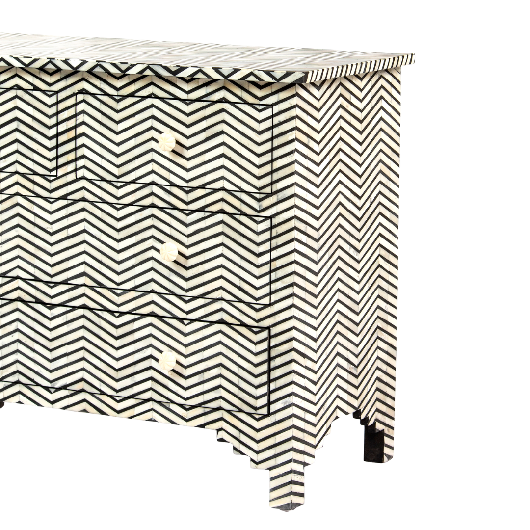 Featuring a Black Bone Inlay Chest of Drawer in chevron pattern, the Isra collection enhances your space with intricately handcrafted designs that elevate your home and living aesthetics. 