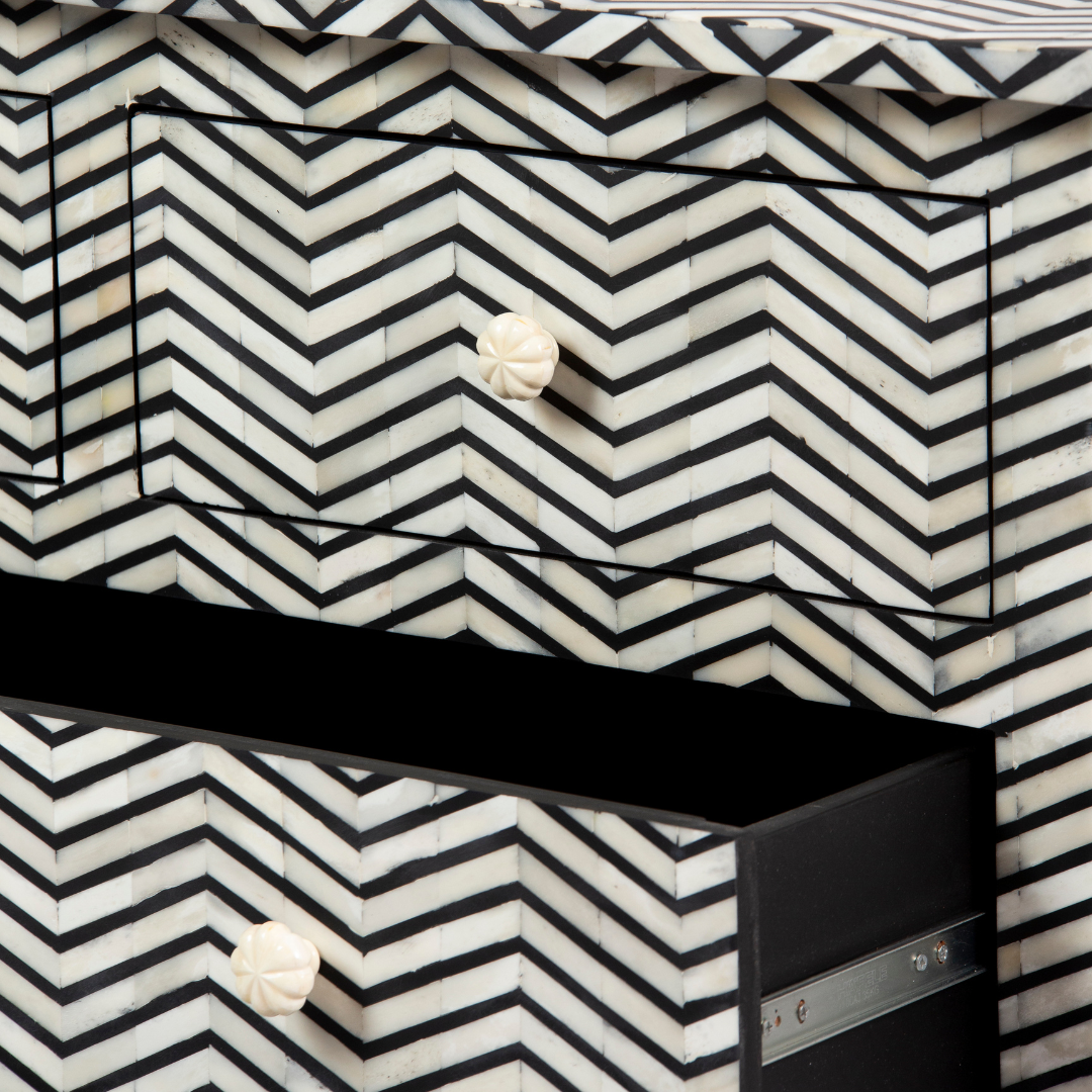 Featuring a Black Bone Inlay Chest of Drawer in chevron pattern, the Isra collection enhances your space with intricately handcrafted designs that elevate your home and living aesthetics. 