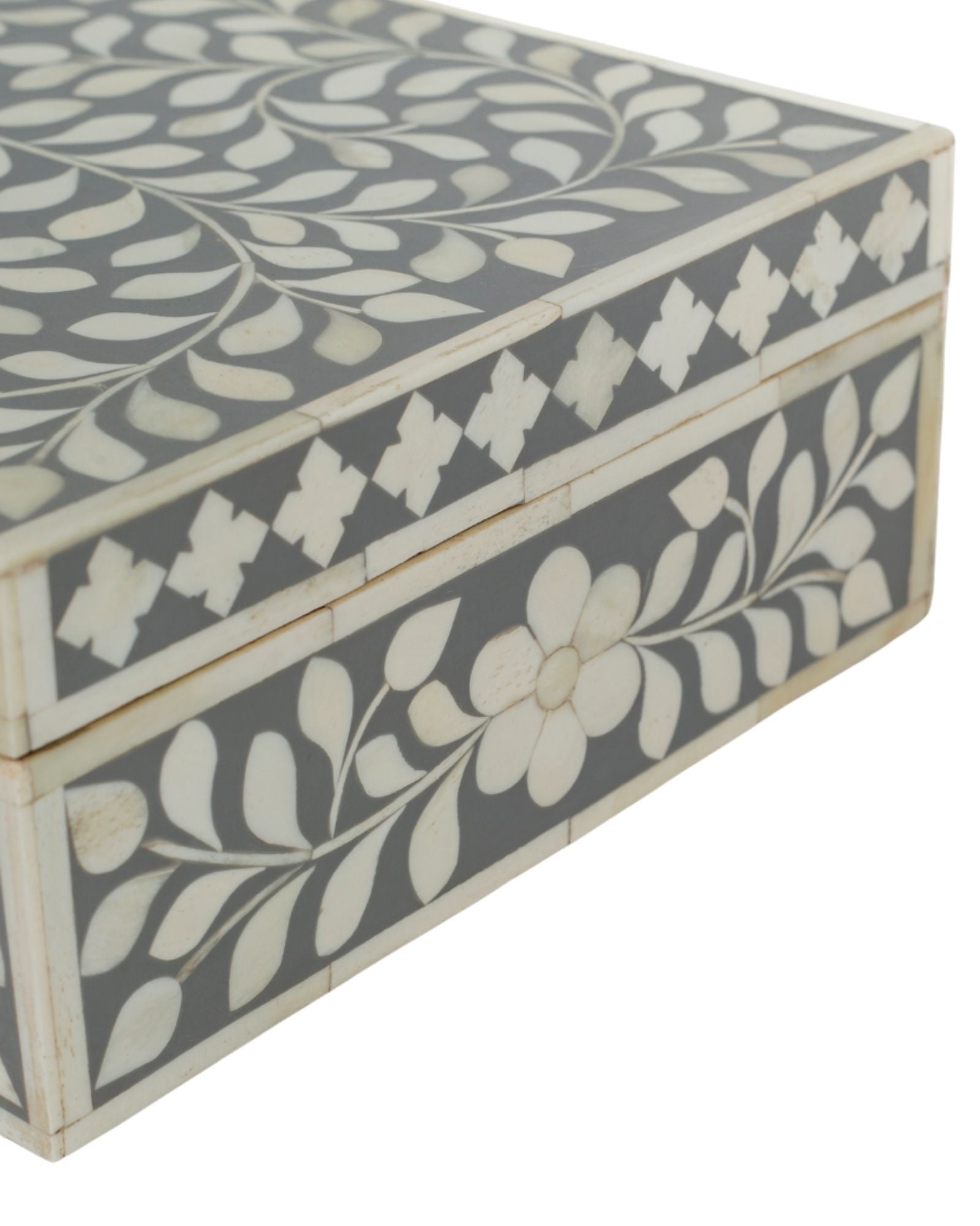 A soft grey decorative box crafted in bone inlay, combining subtle tones with intricate floral detailing.