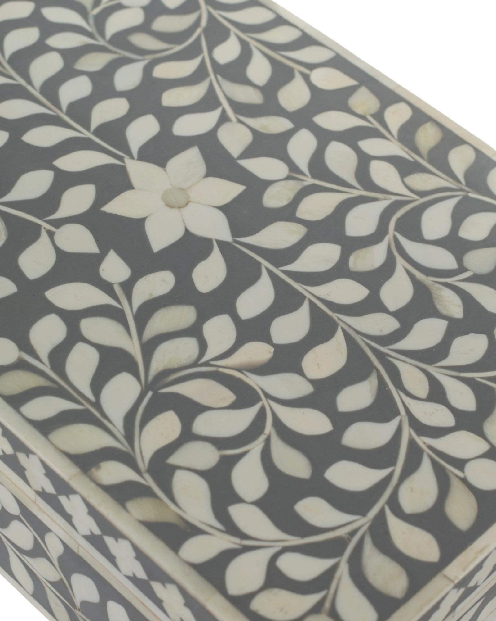 A soft grey decorative box crafted in bone inlay, combining subtle tones with intricate floral detailing.