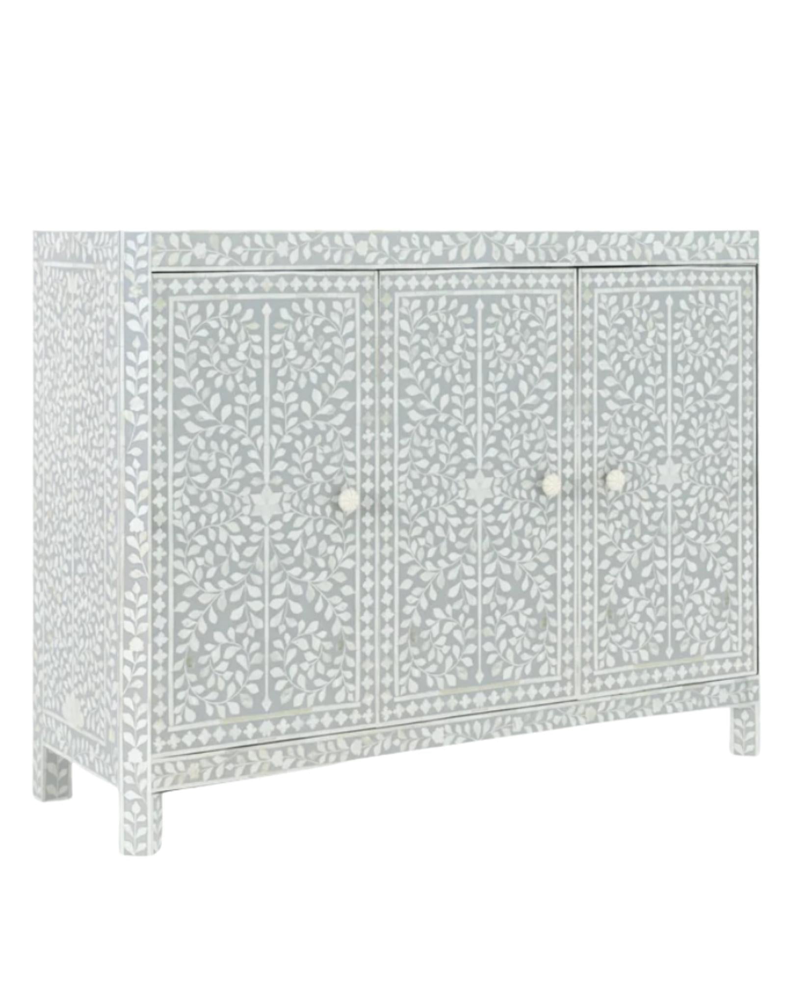 Handcrafted grey Cabinet with intricate Bone inlay, featuring a floral pattern and sleek Bone legs. A luxurious storage solution for any space. 
