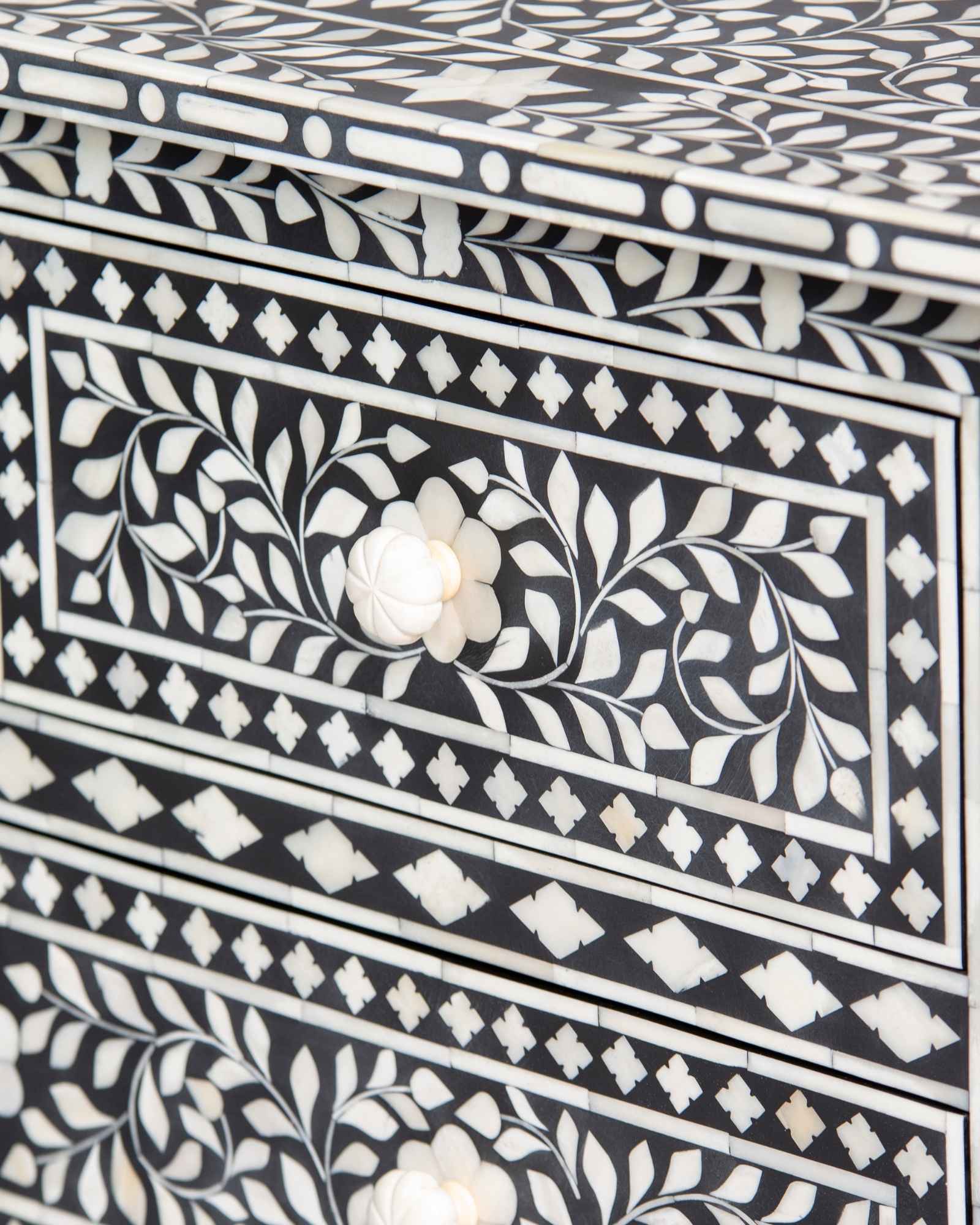 Bone inlay chest of drawers featuring intricate floral pattern in black and white, handcrafted furniture piece.