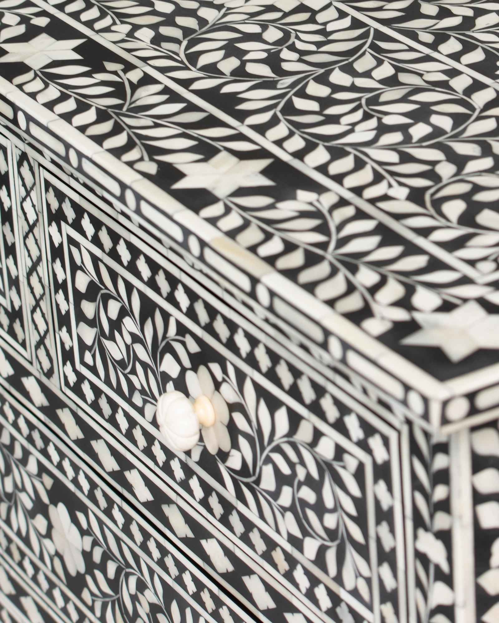 Bone inlay chest of drawers featuring intricate floral pattern in black and white, handcrafted furniture piece.
